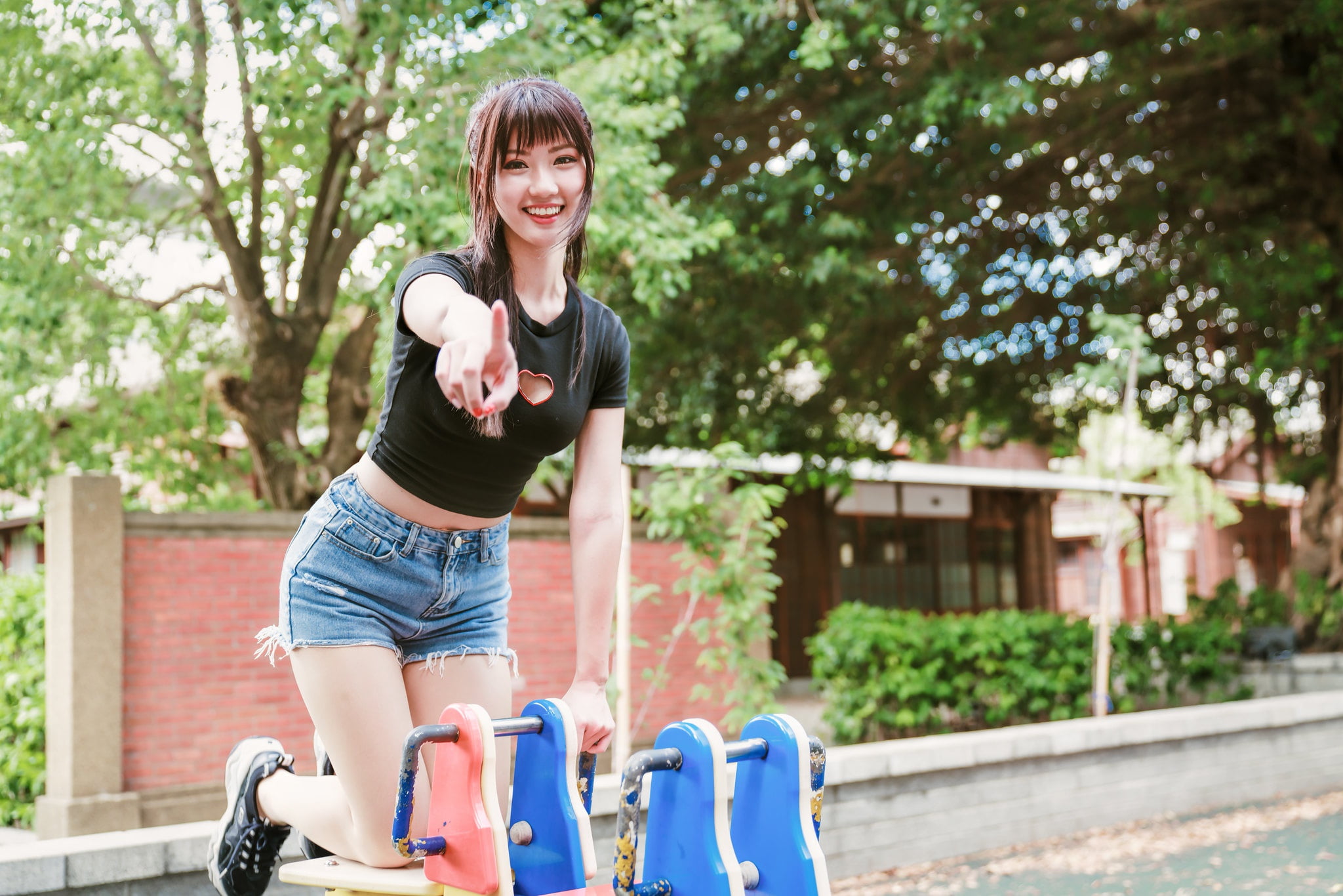 trees, shorts, black shirt, model, long hair, brunette, finger pointing, women, jeans, Asian, 1080P, bricks, wall, Bushes, HD Wallpaper