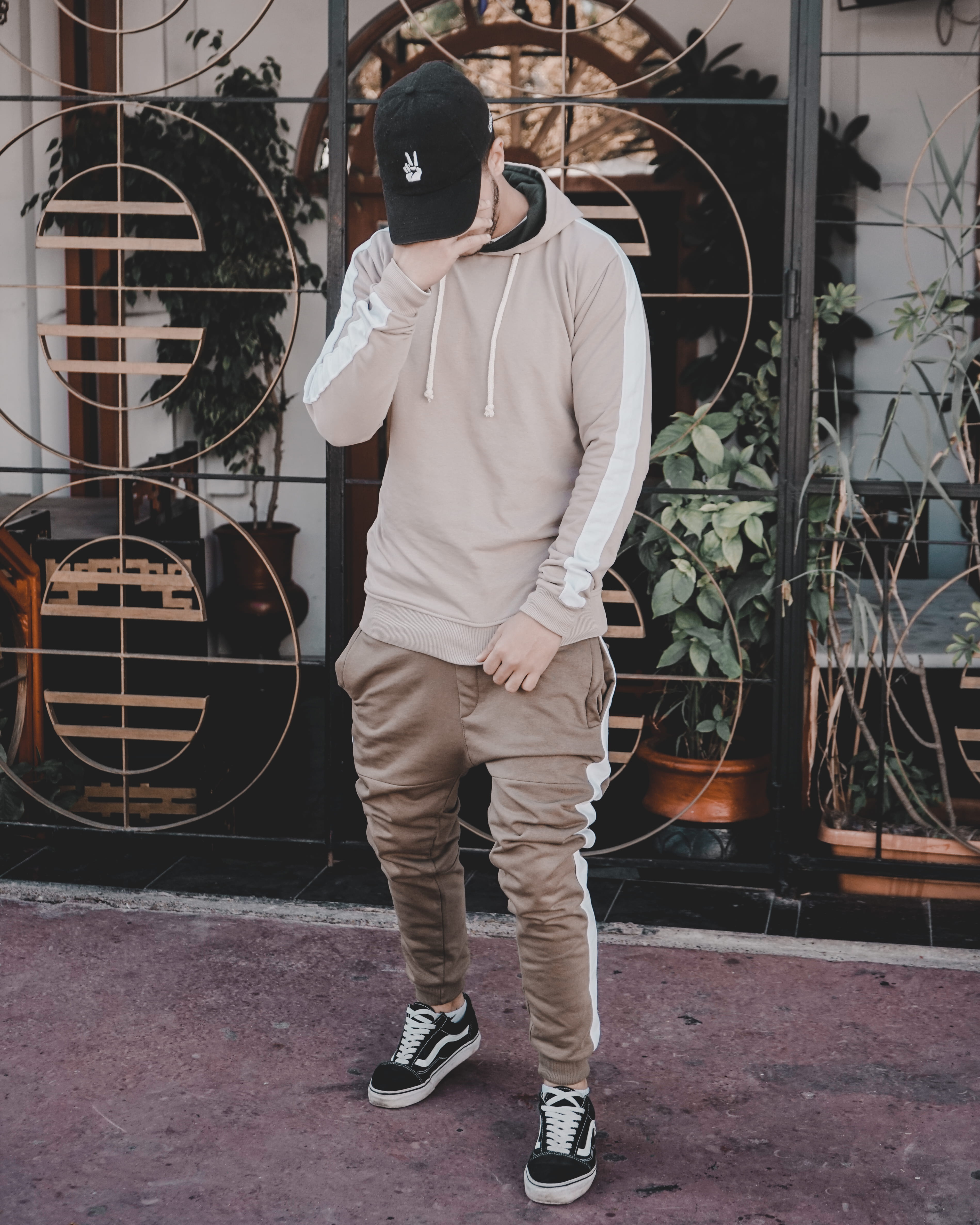 person, architecture, cap, hat, man, casual clothing, right, day, covering, lifestyles, face, young adult, hand, metal, building exterior, real people, Phone HD Wallpaper