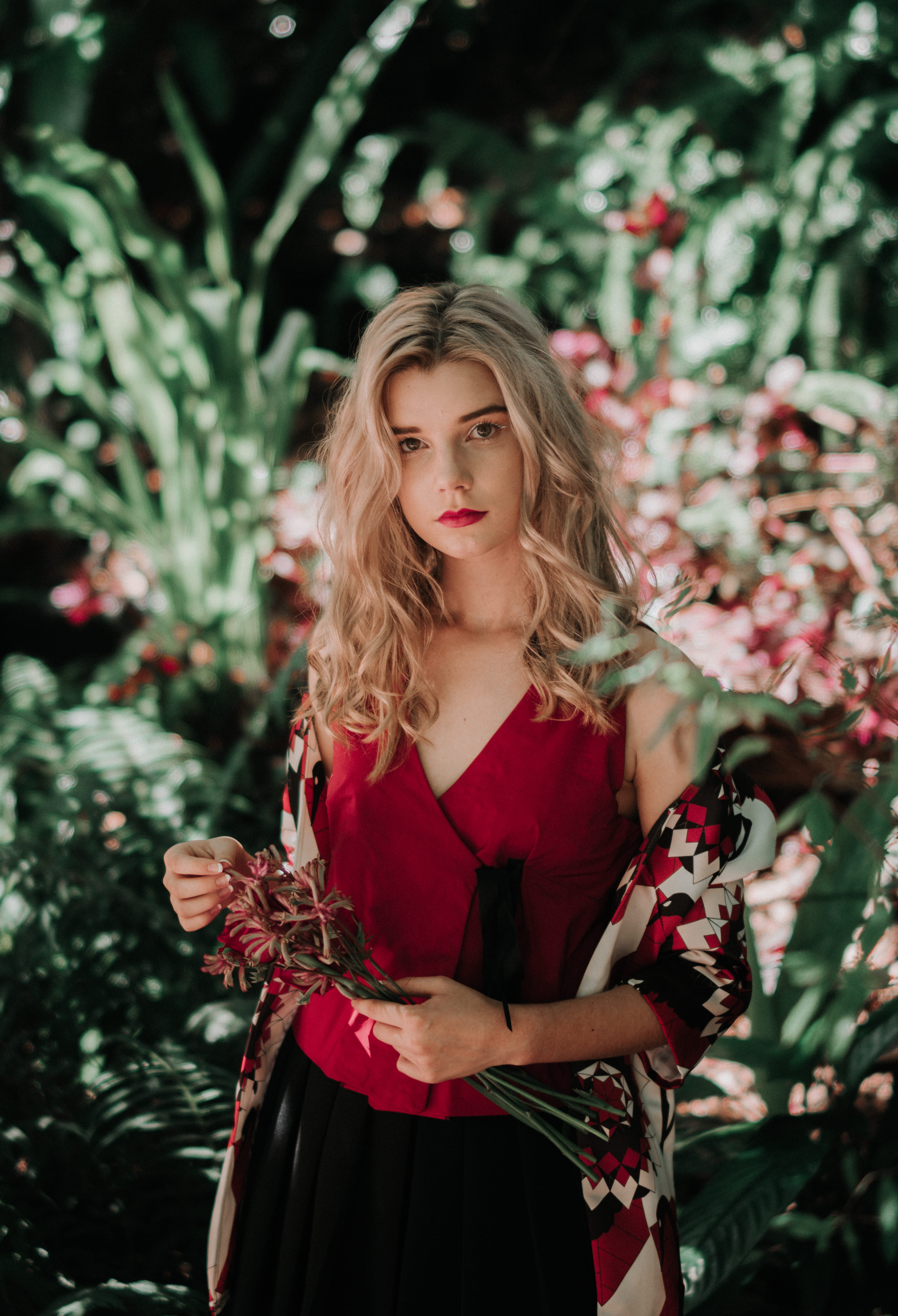 tank, daytime, plant, red, blonde, face, neck, human, young women, woman, front, waist up, female, hair, shawl, lady, bouquet, nature, one person, white, Phone HD Wallpaper