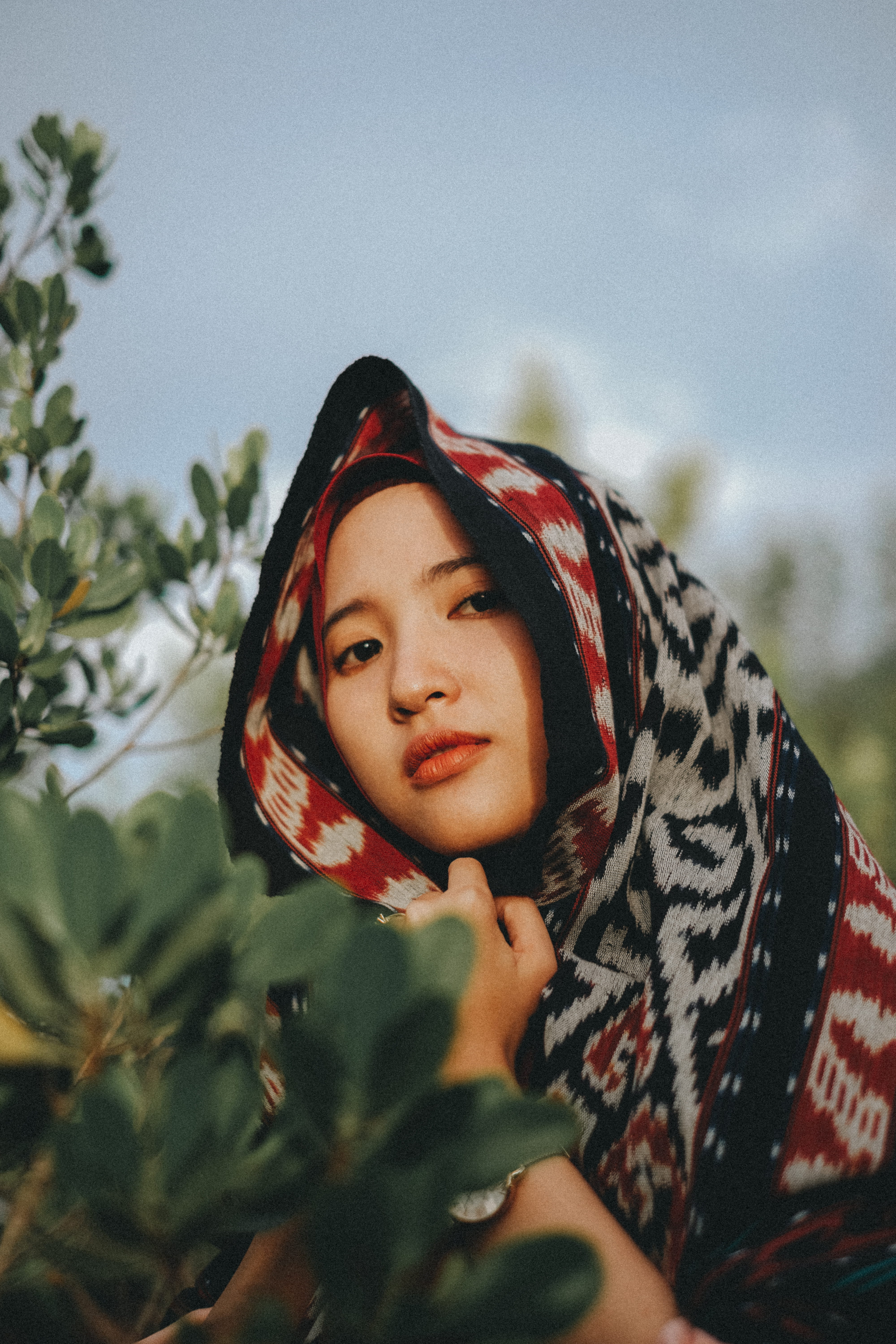 human Face, plants, islam, traditional Clothing, portrait, beautiful, one Person, headscarf, day, front, greenery, women, smiling, red, foliage, scarf, Phone HD Wallpaper