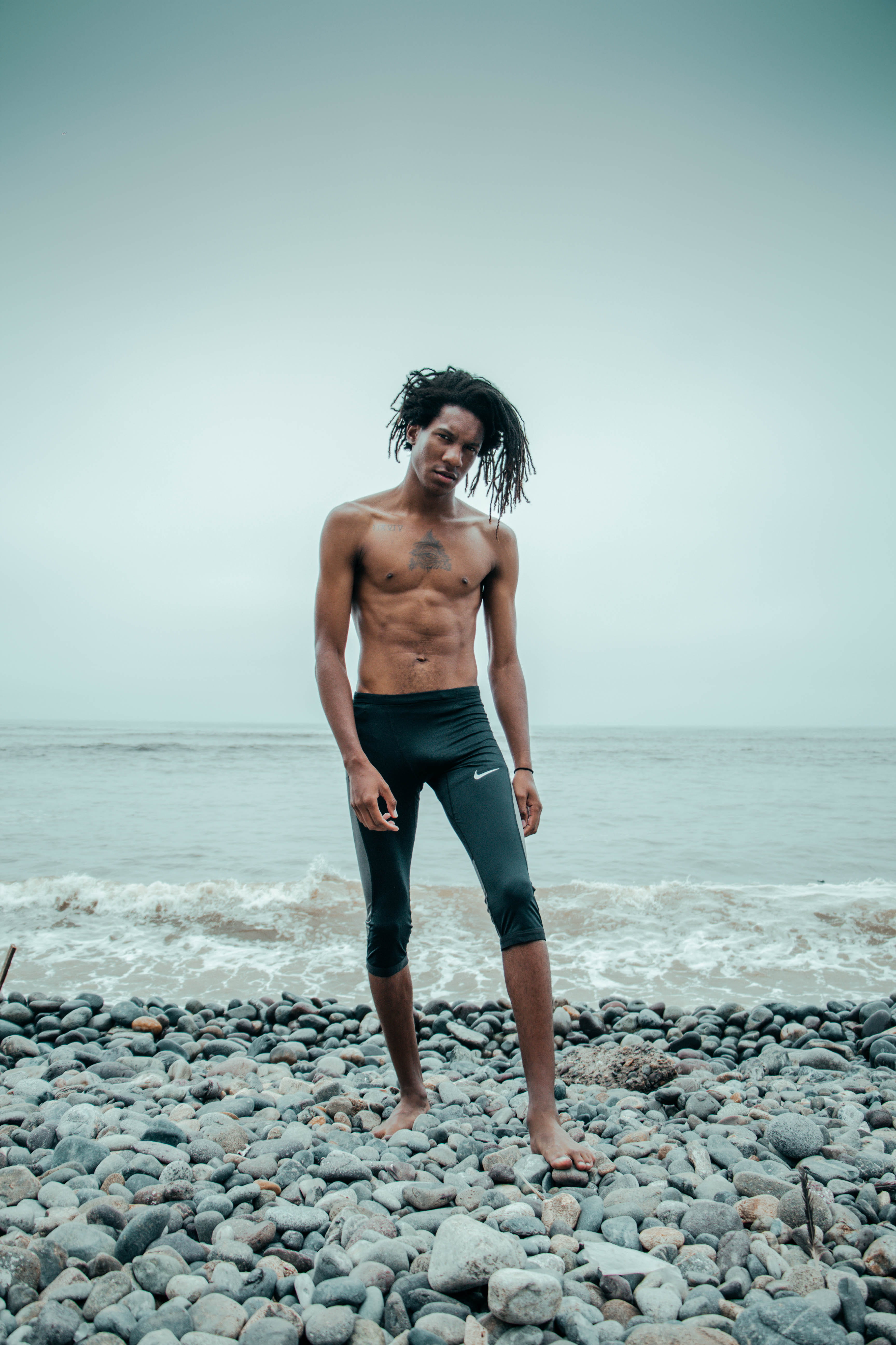 male, beach, seashore, full length, man, shorts, wearing, 5K, water, real people, standing, horizon, horizon over water, solid, sky, land, pants, hairstyle, Phone HD Wallpaper