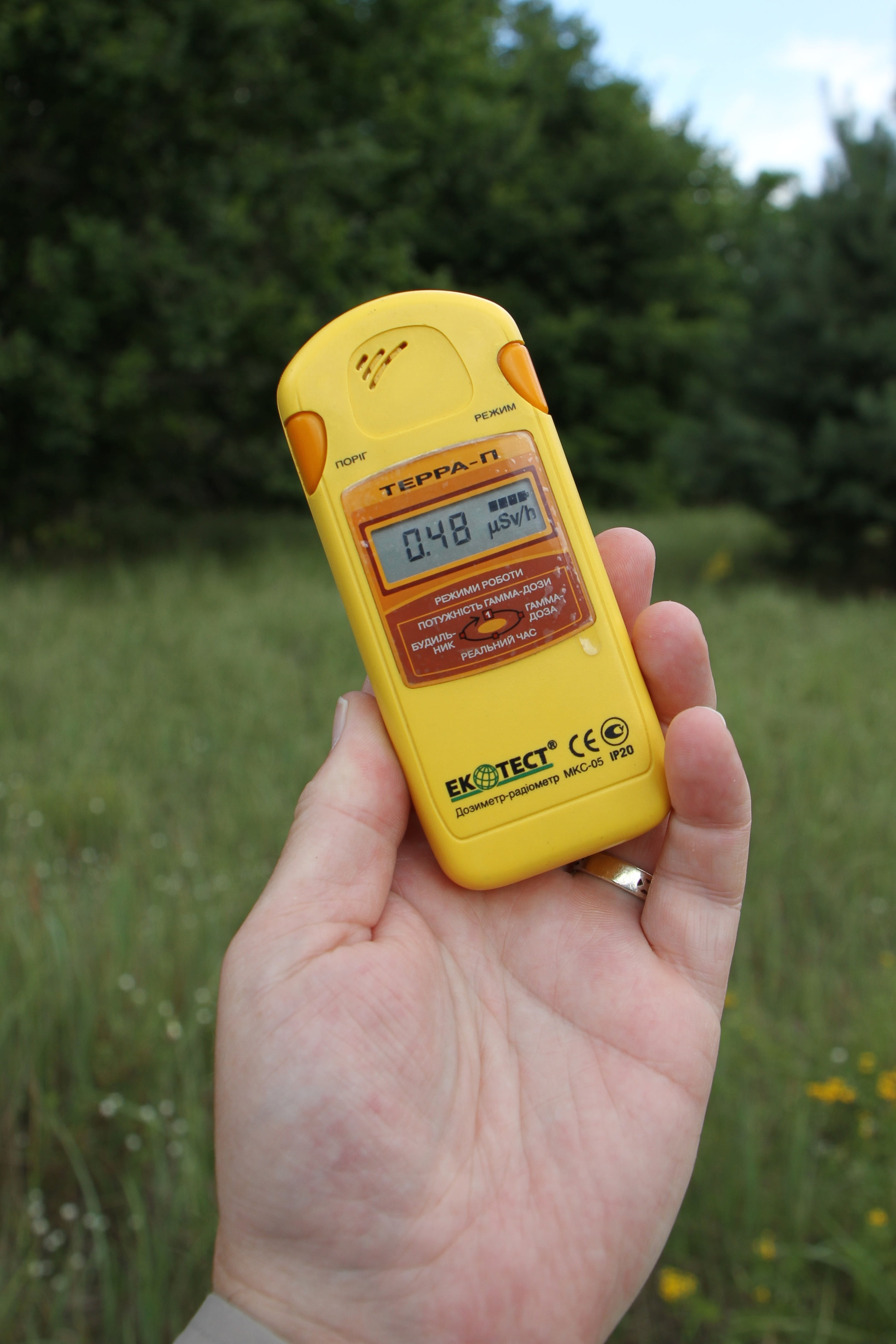 outdoors, radioactivity, focus on foreground, dosimeter, real people, hand, human body part, text, technology, day, human limb, one person, unrecognizable person, Phone HD Wallpaper