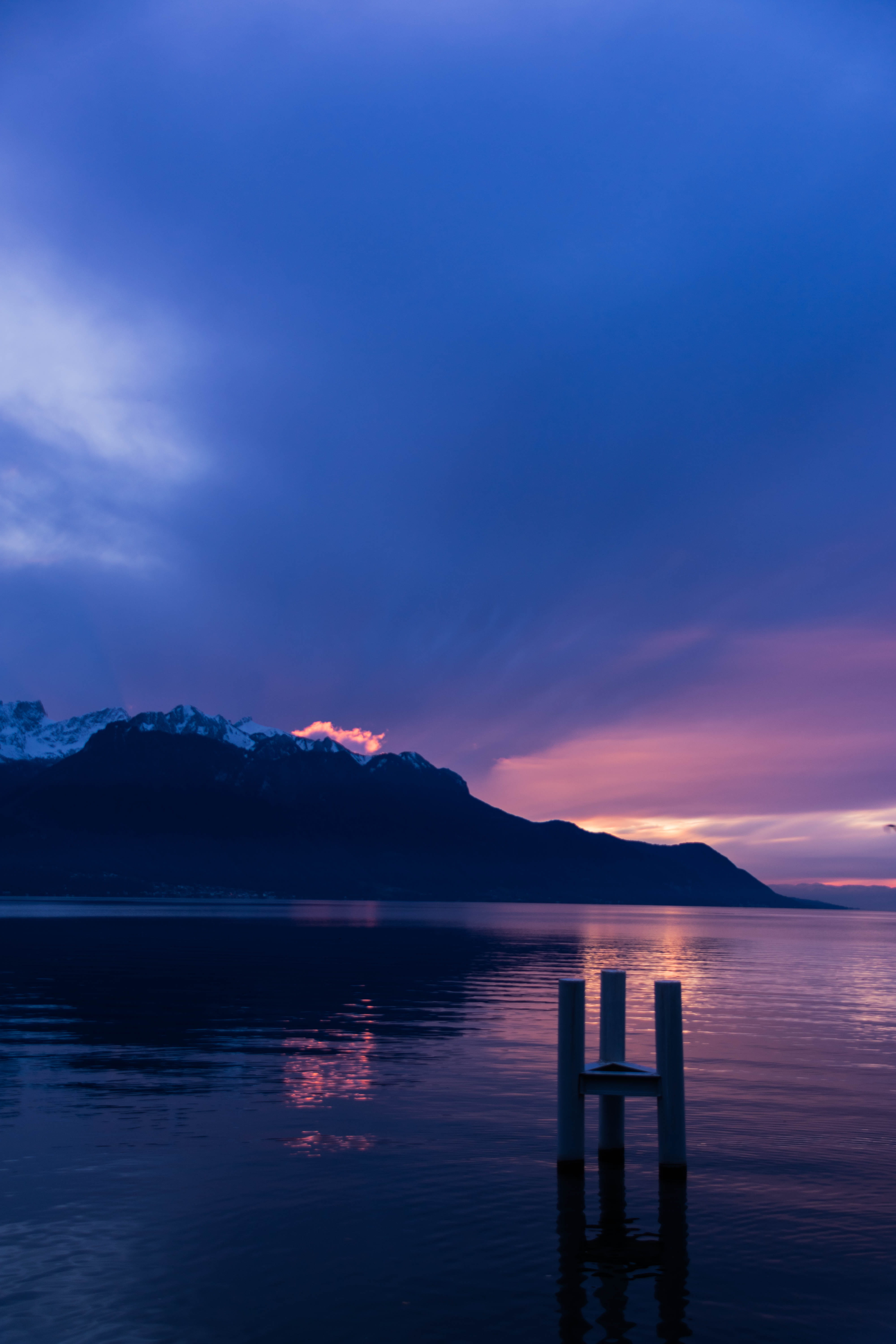 dusk, mountain, moody, pink, clouds, waterfront, idyllic, nature, fire, mountain range, sky, background, water, reflection, blue, winter, no people, wooden post, Phone HD Wallpaper