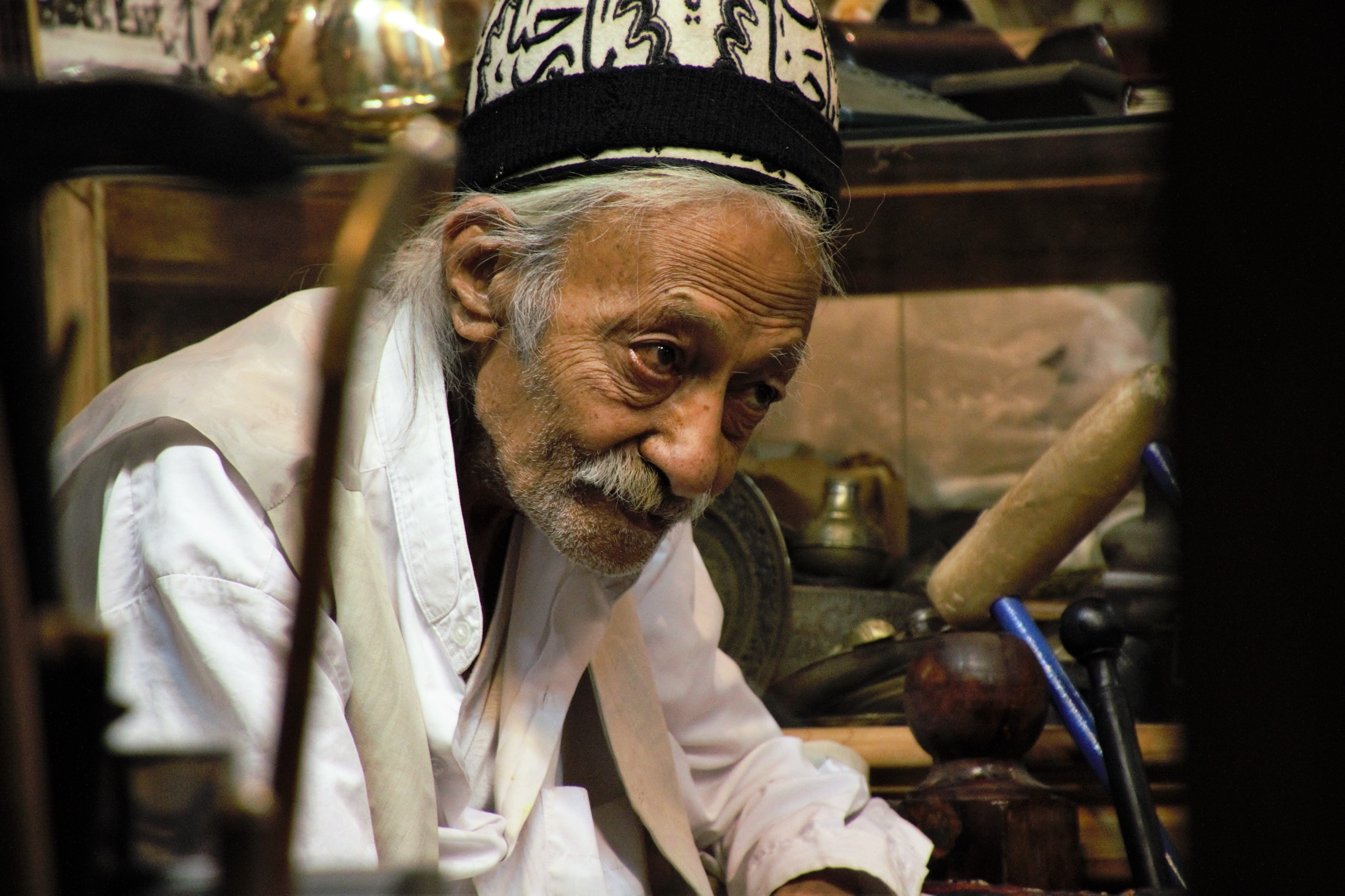 focus on foreground, old man, men, beard, smiling, clothing, headshot, occupation, males, one person, business, indoors, metal shop, incidental people, HD Wallpaper