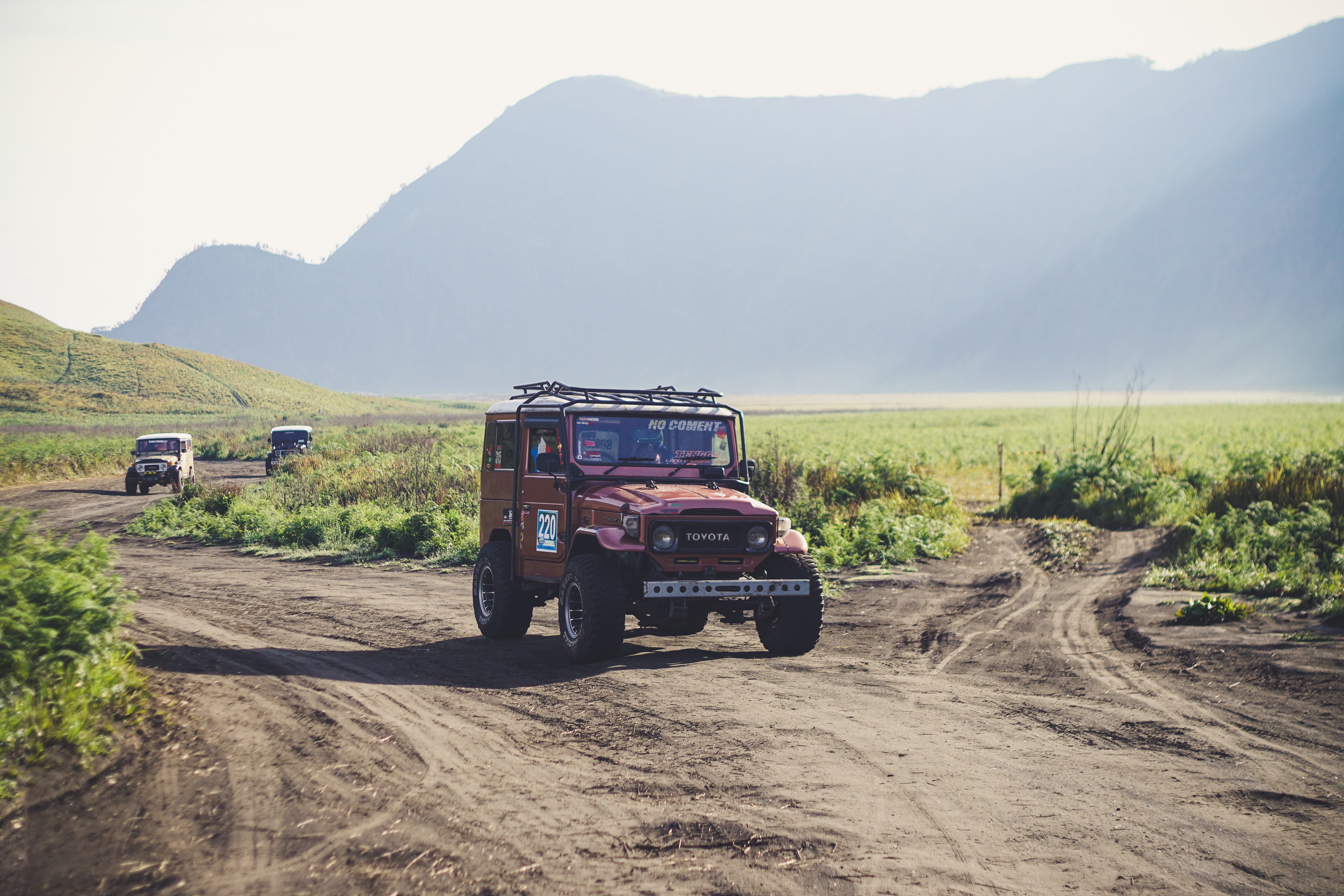 mode of transportation, rural scene, field, transportation, surrounded, road, daytime, pathway, dirt road, sunlight, land vehicle, one person, environment, HD Wallpaper