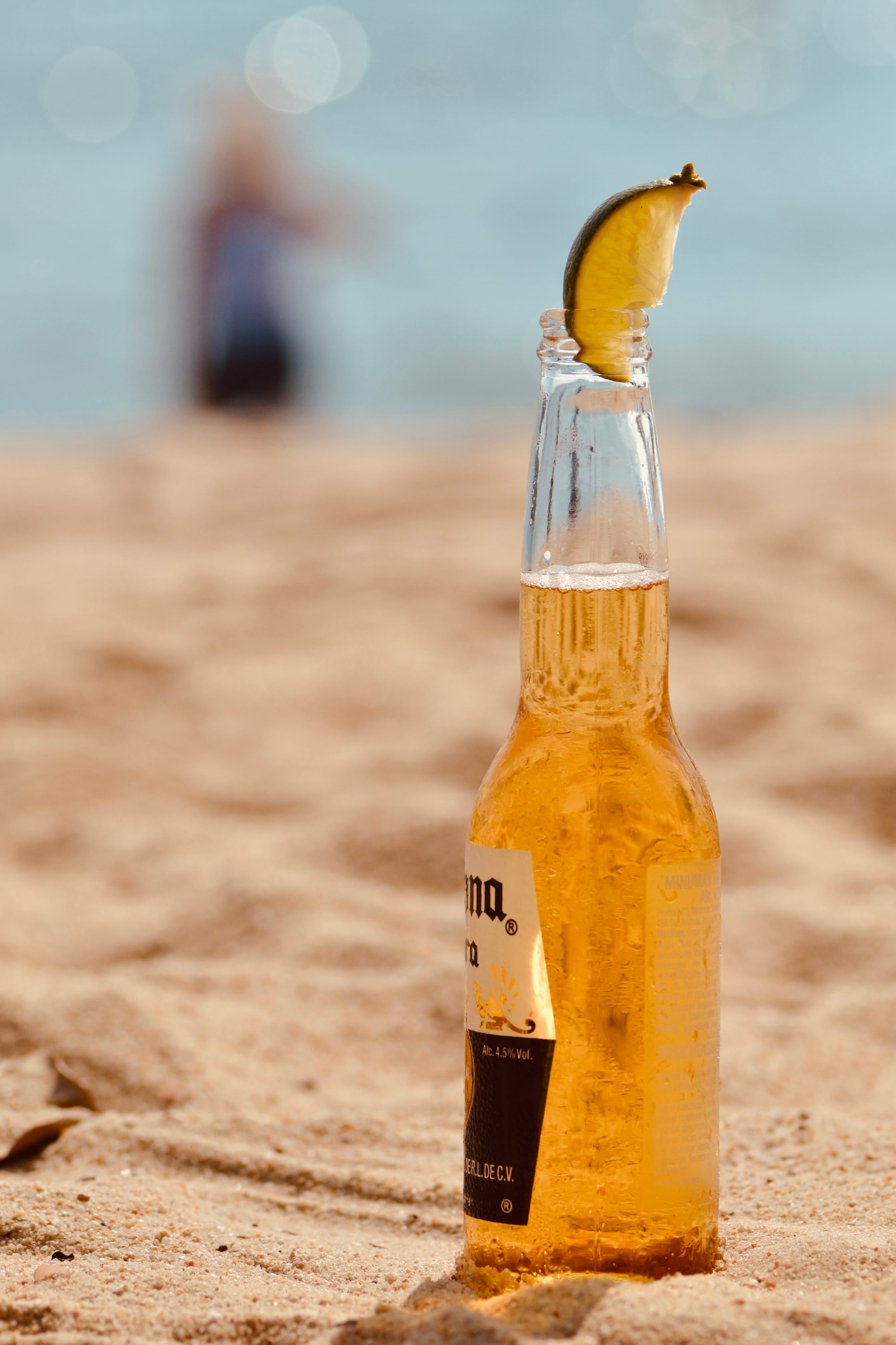 land, corona, beer bottle, bottle, focus on foreground, glass - material, nature, 4K, seashore, day, food, liquor, table, beach, container, holiday, across, Phone HD Wallpaper