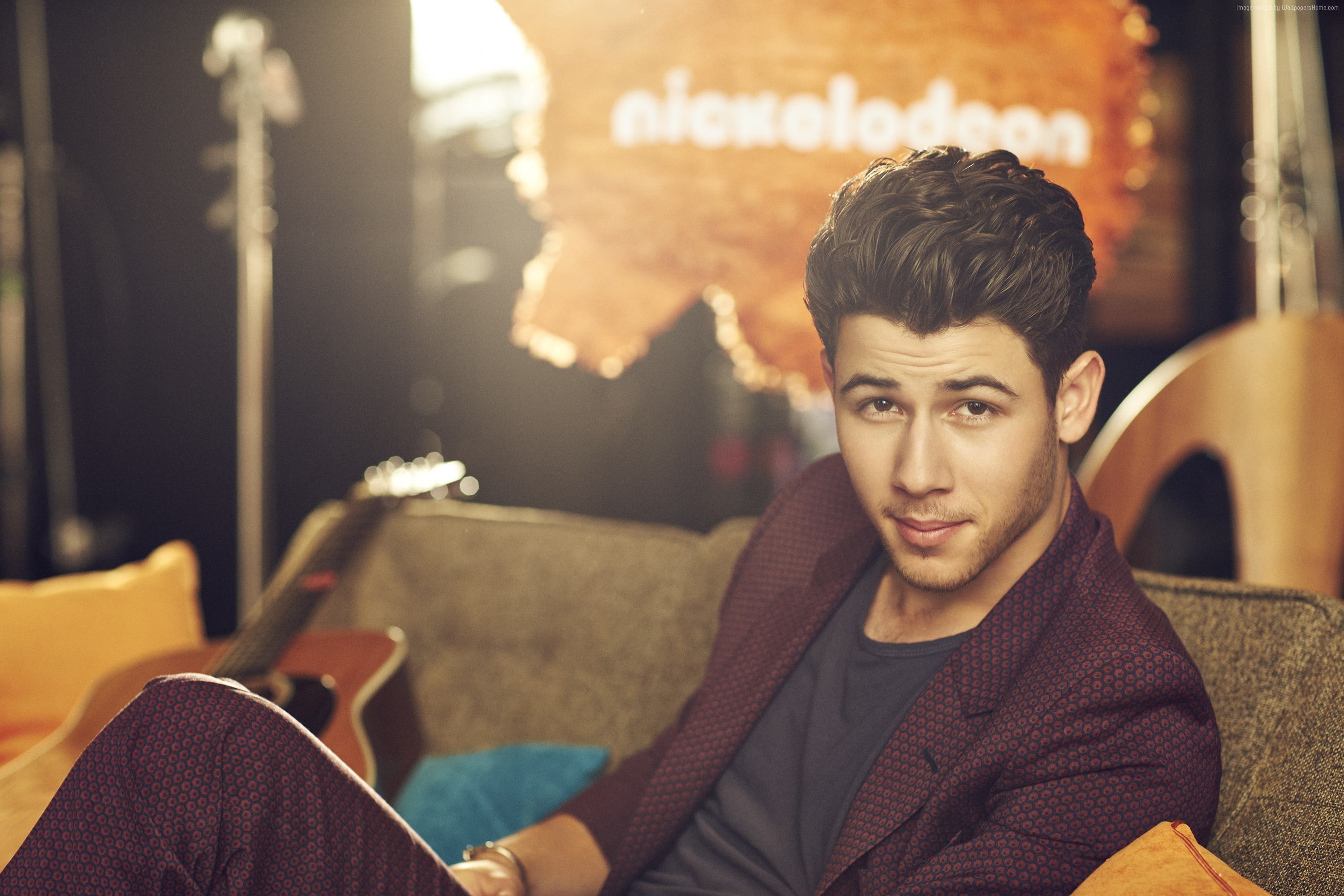 brown hair, indoors, smiling, Nick Jonas, casual clothing, 2K, one person, adult, relaxation, furniture, looking at camera, emotion, Top music artist and bands, HD Wallpaper