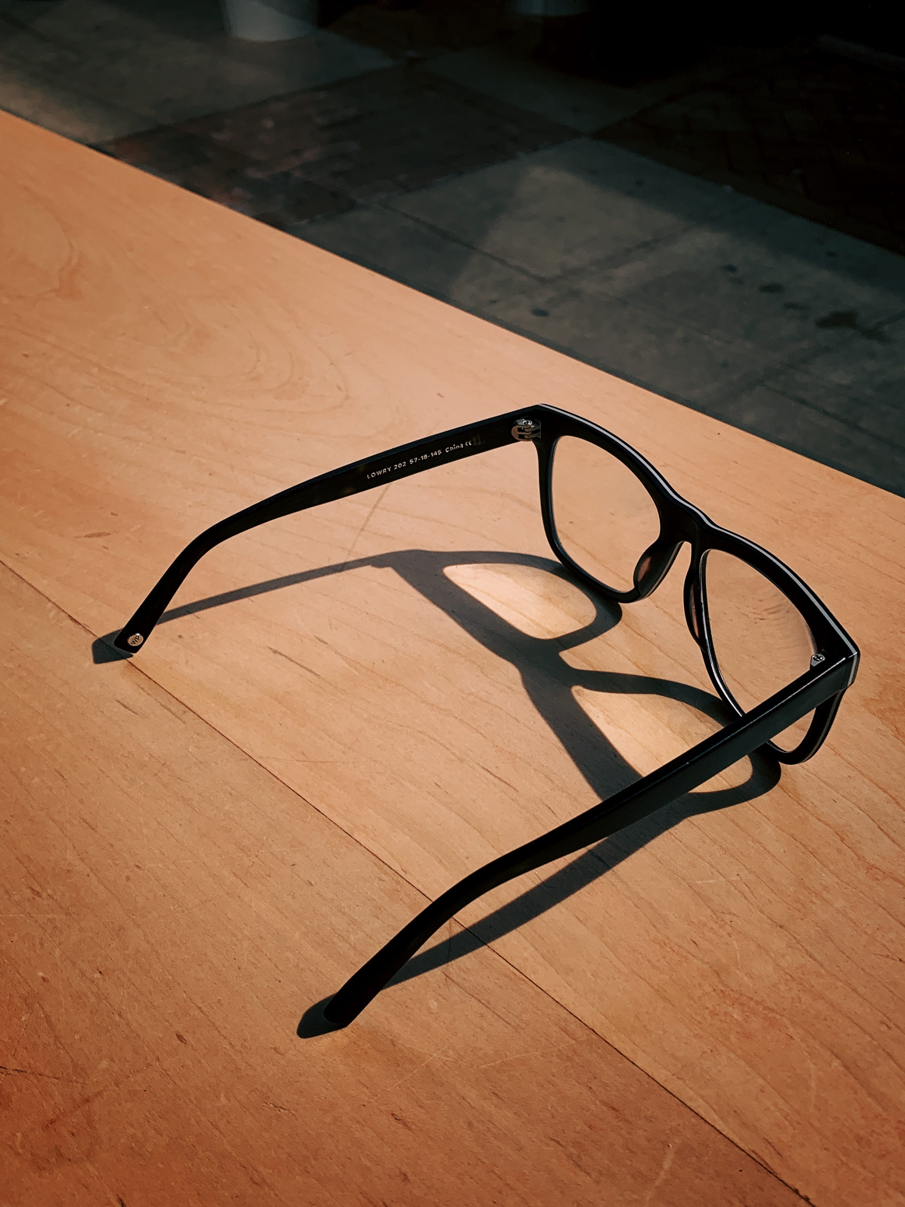 single object, brown, glass - material, hardwood, shadow, eyeglasses, accessories, black color, high angle view, close-up, flooring, electronics, indoors, Phone HD Wallpaper