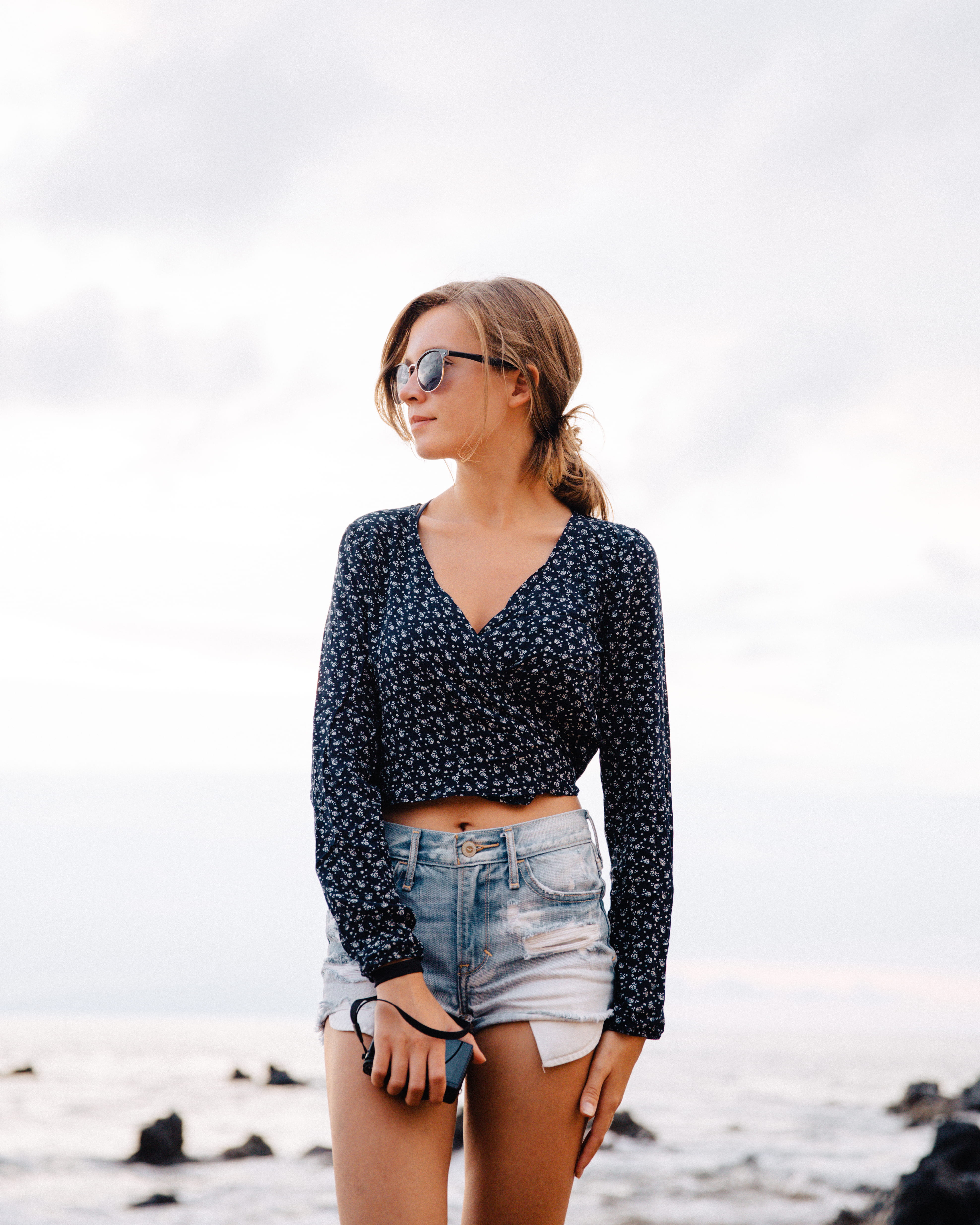 sea, standing, young adult, hairstyle, photoshoot, young women, outdoors, beach, water, beauty, shorts, sunglasses, smiling, women, sleeve, lady, leisure activity, Phone HD Wallpaper