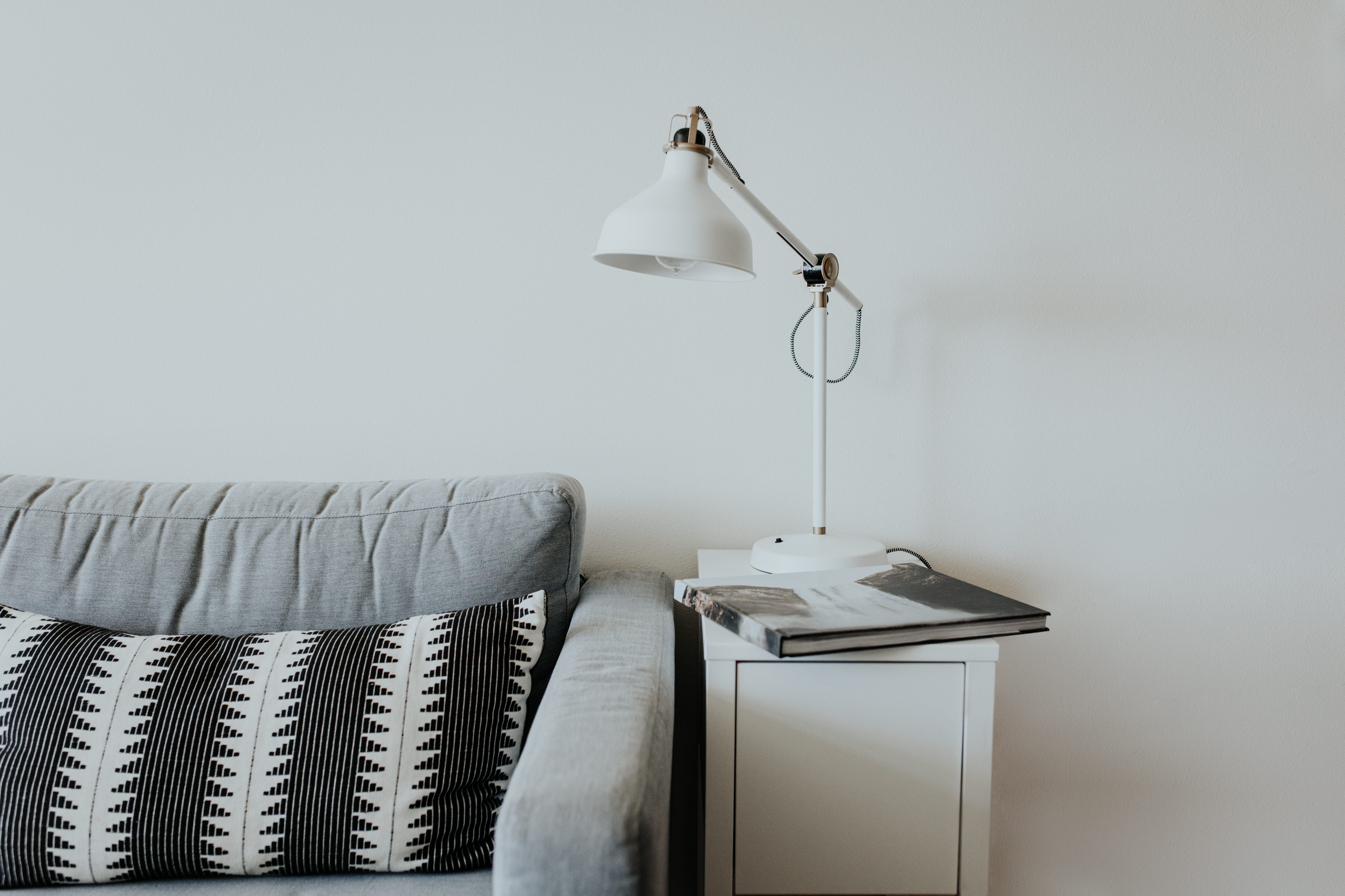 sofa, near, lighting equipment, condo, night table, domestic life, home interior, no people, beside, technology, pillow, indoors, minimal, gray, lamp, light, HD Wallpaper