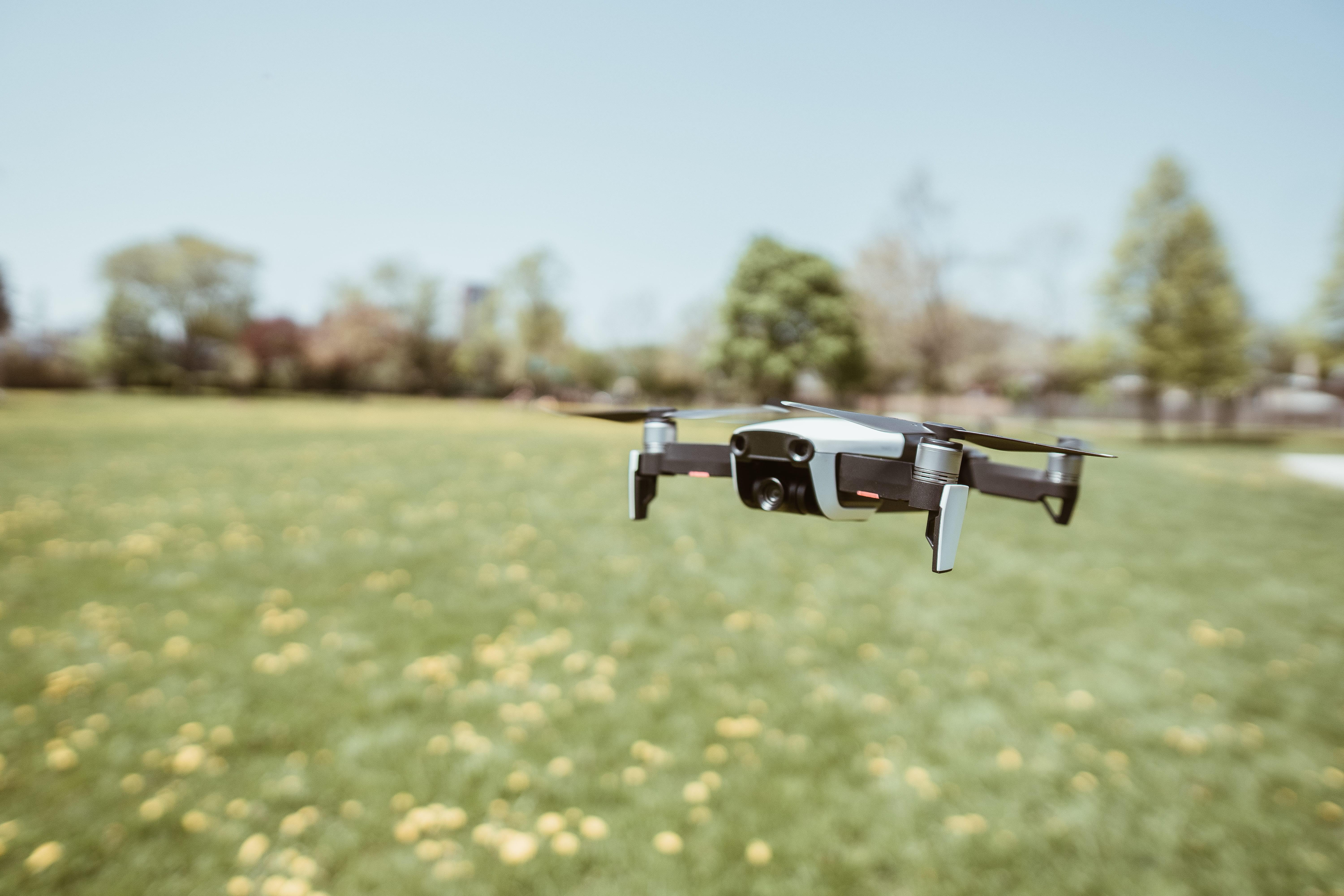 drone in park, close-up, flying, weapon, tech, in the air, flora, day, metal, white drone, safety, white, land, selective focus, dji mavic air, small drone, HD Wallpaper