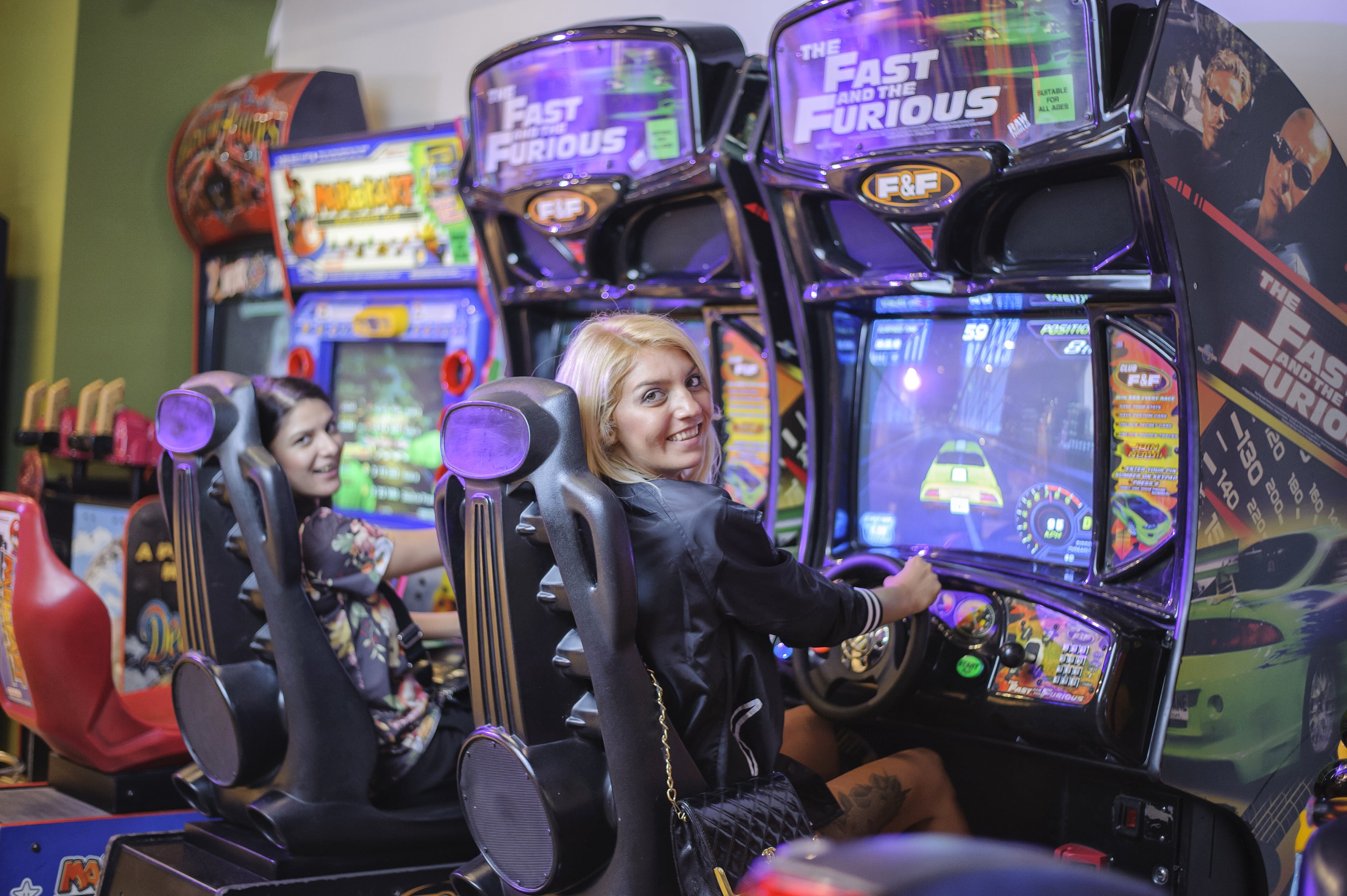 simulator, mid adult women, young adult, slot machine, game, girls playing, lifestyles, young women, fast and the furious, drive, leisure activity, 2K, HD Wallpaper