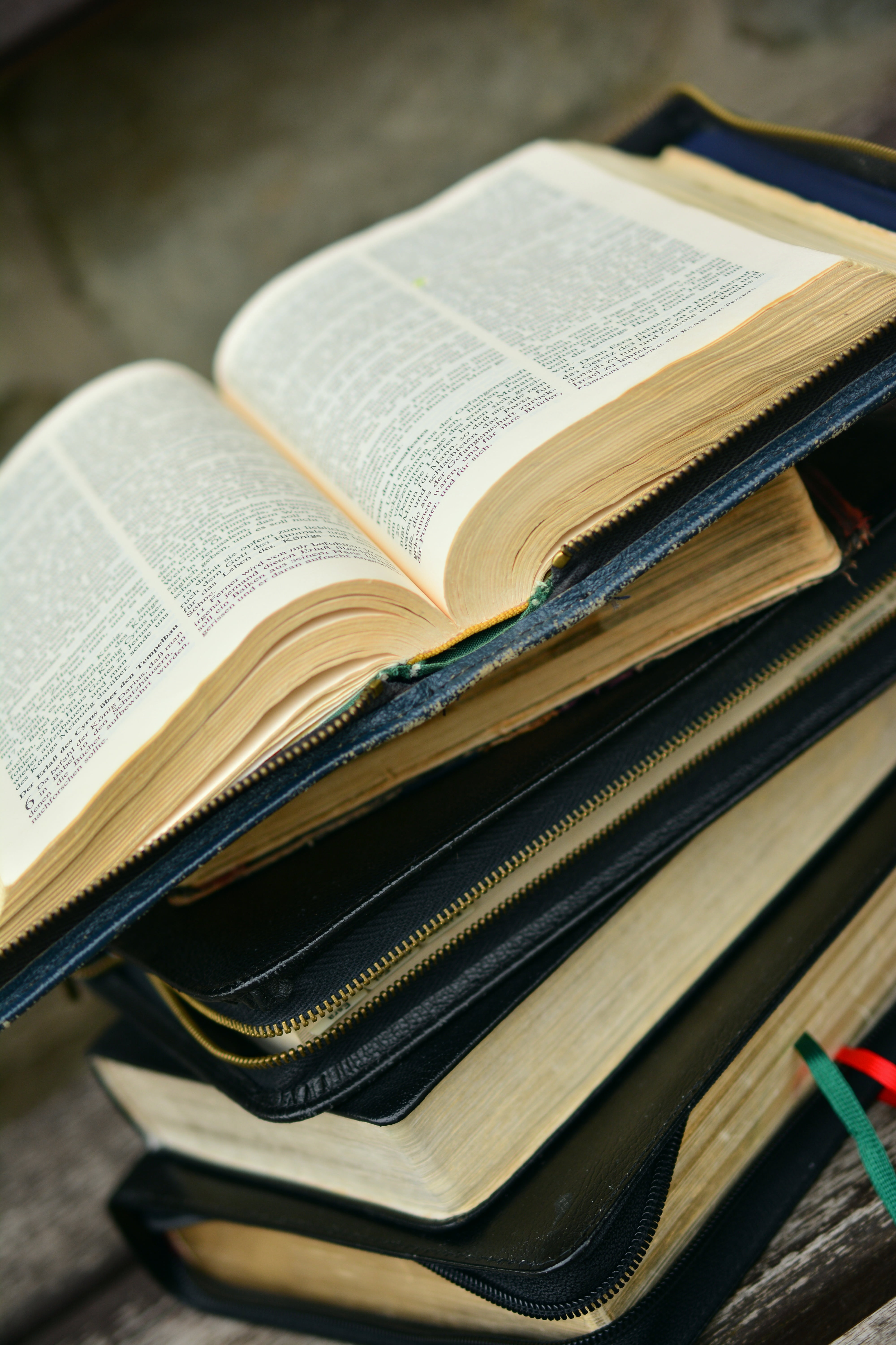 faith religious, bible, literature, learning, brown, pages, religion, education, stack, focus on foreground, pile, day, indoors, blue, selective focus, Phone HD Wallpaper