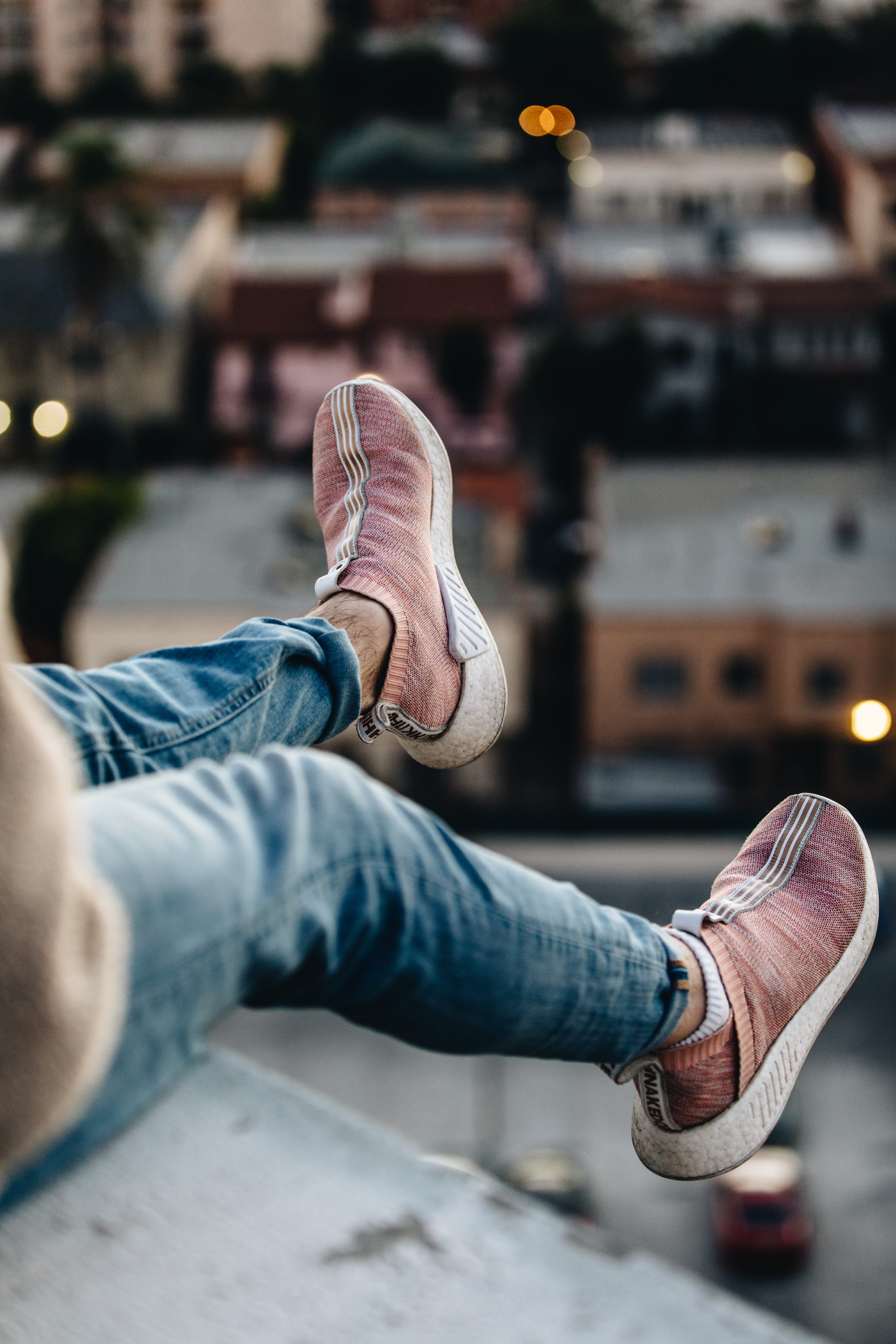 low section, focus, pair, photography, feet, men, human foot, sitting, architecture, selective, lifestyles, jeans, body part, 5K, swaying, city, denim, Phone HD Wallpaper