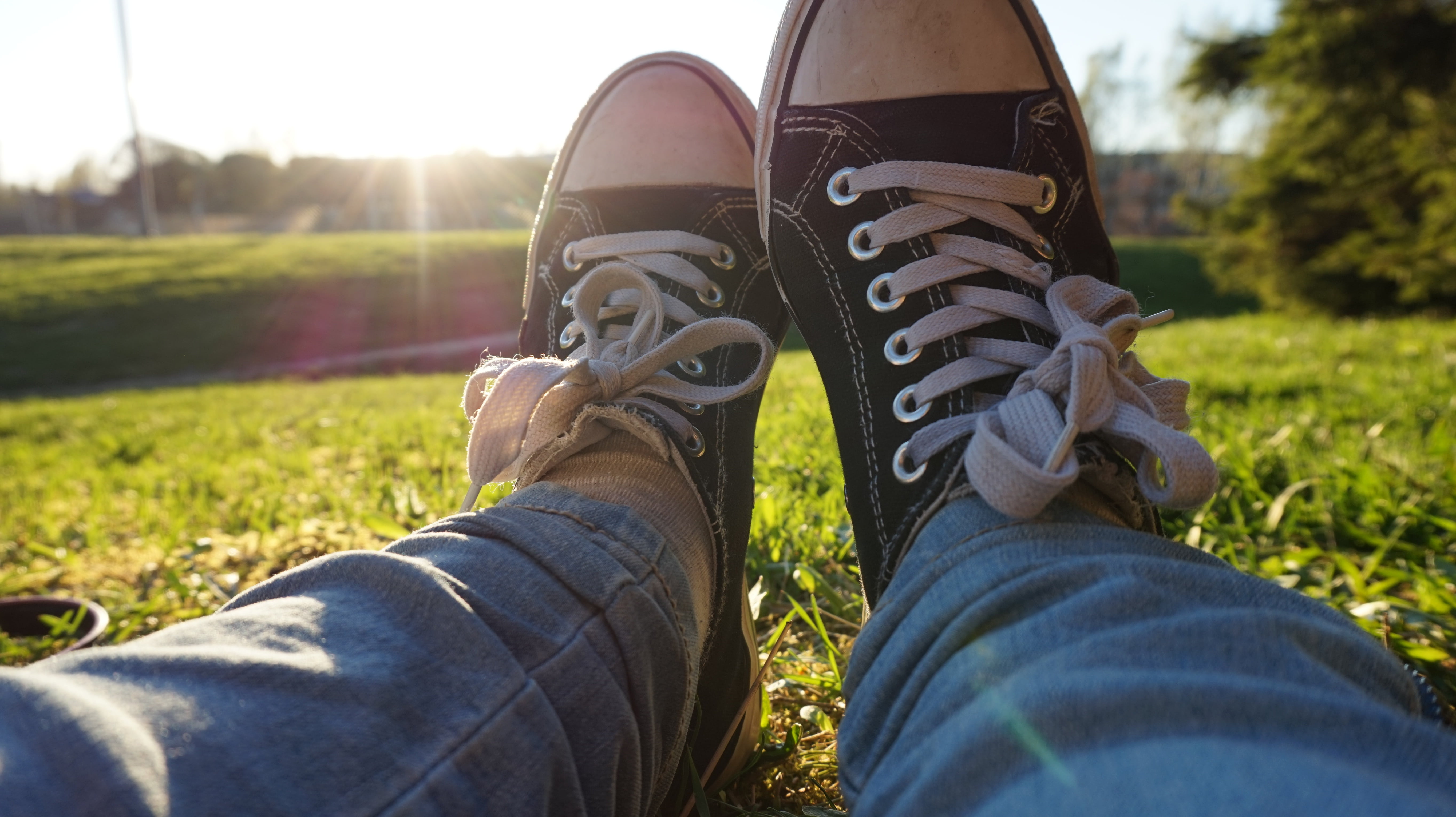 jeans, casual clothing, light, limb, nature, real people, converse, human limb, relaxation, park, low, white, grass, day, leisure activity, land, low section, HD Wallpaper