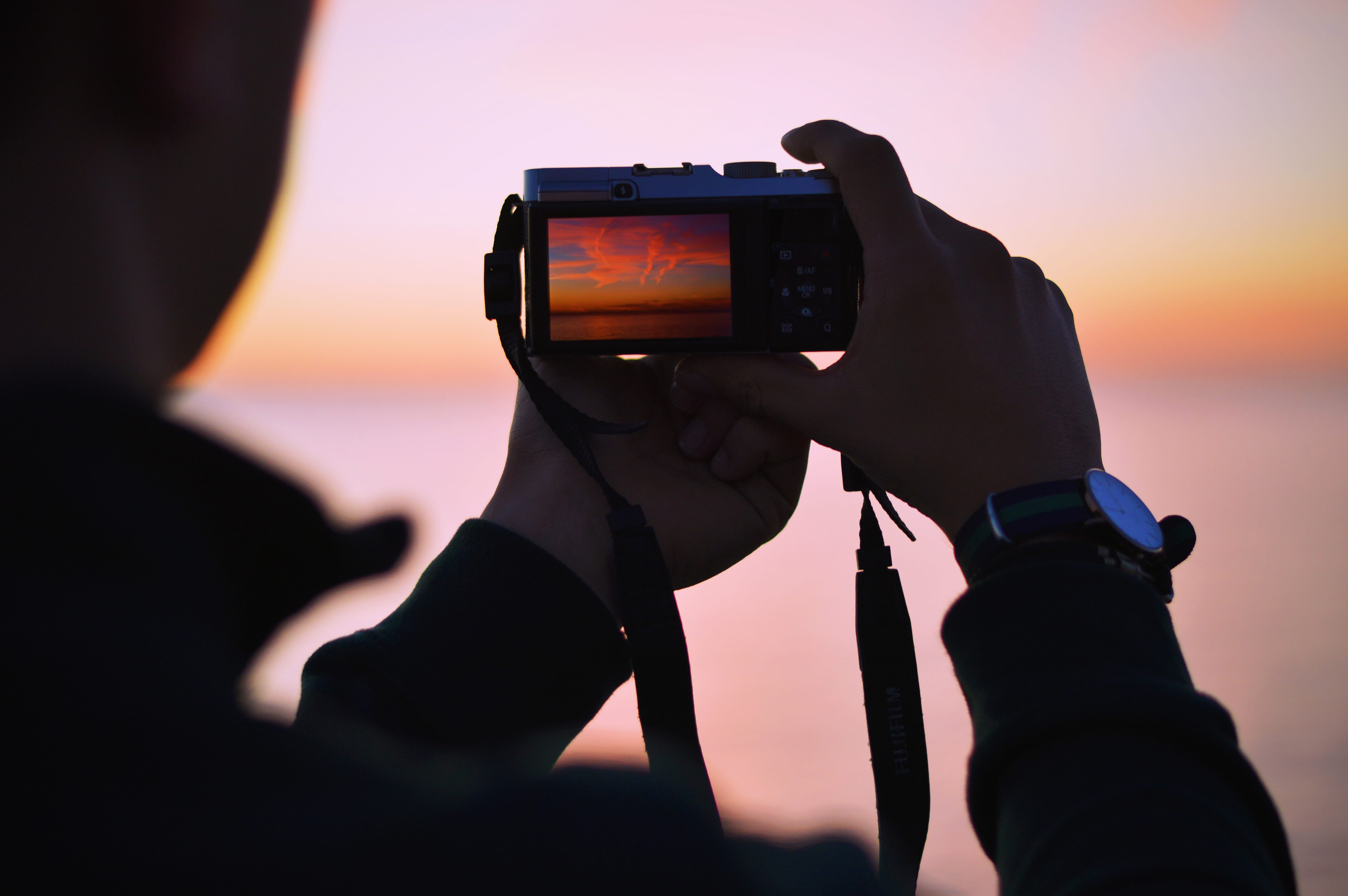 person, watch, photo, photographic equipment, sunset, communication, holding, gear, activity, leisure activity, camera - photographic equipment, tech, digital camera, HD Wallpaper