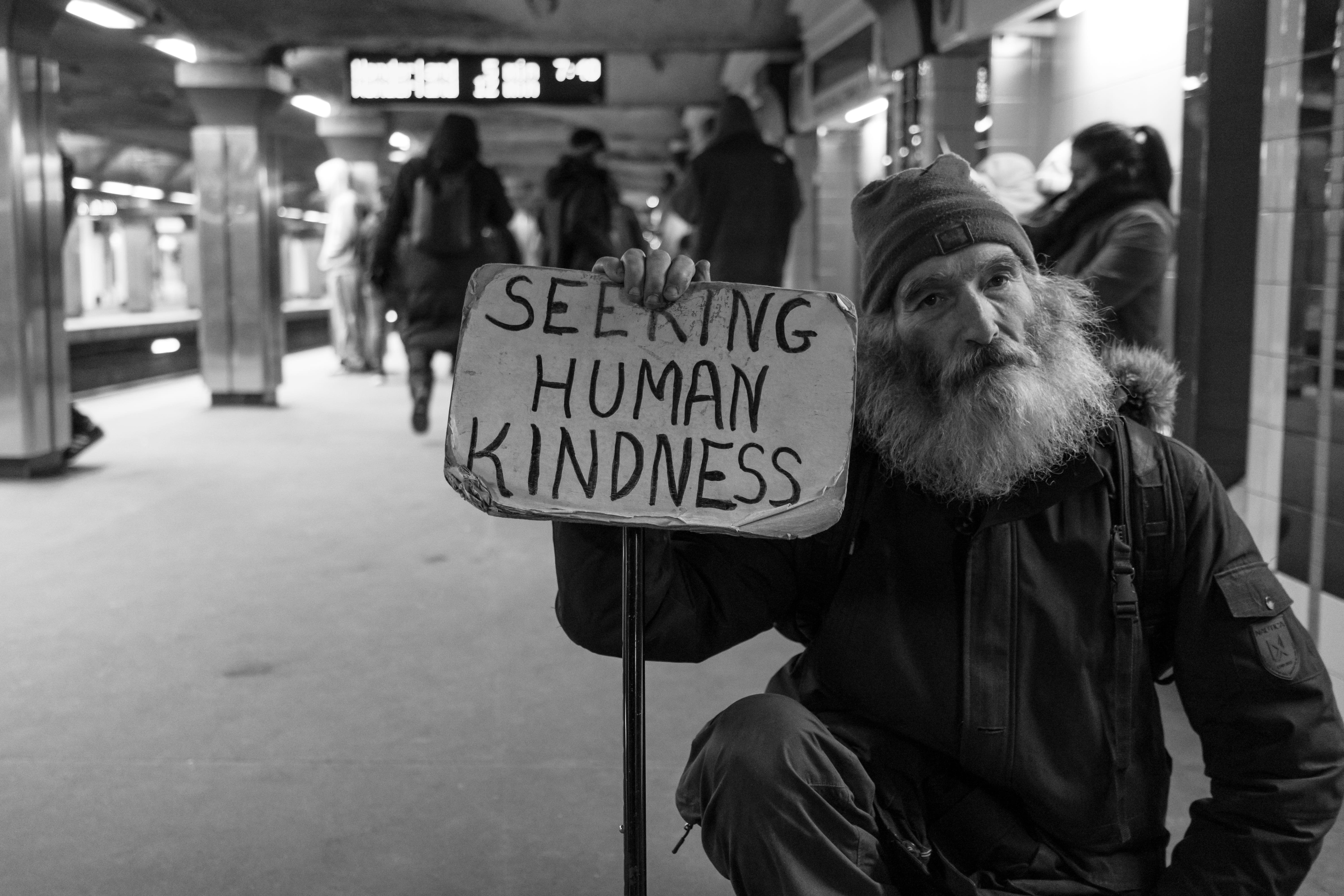 signage, city, men, man, text, holding, station, kindness, male, 5K, incidental people, human, western script, focus on foreground, card, real people, HD Wallpaper