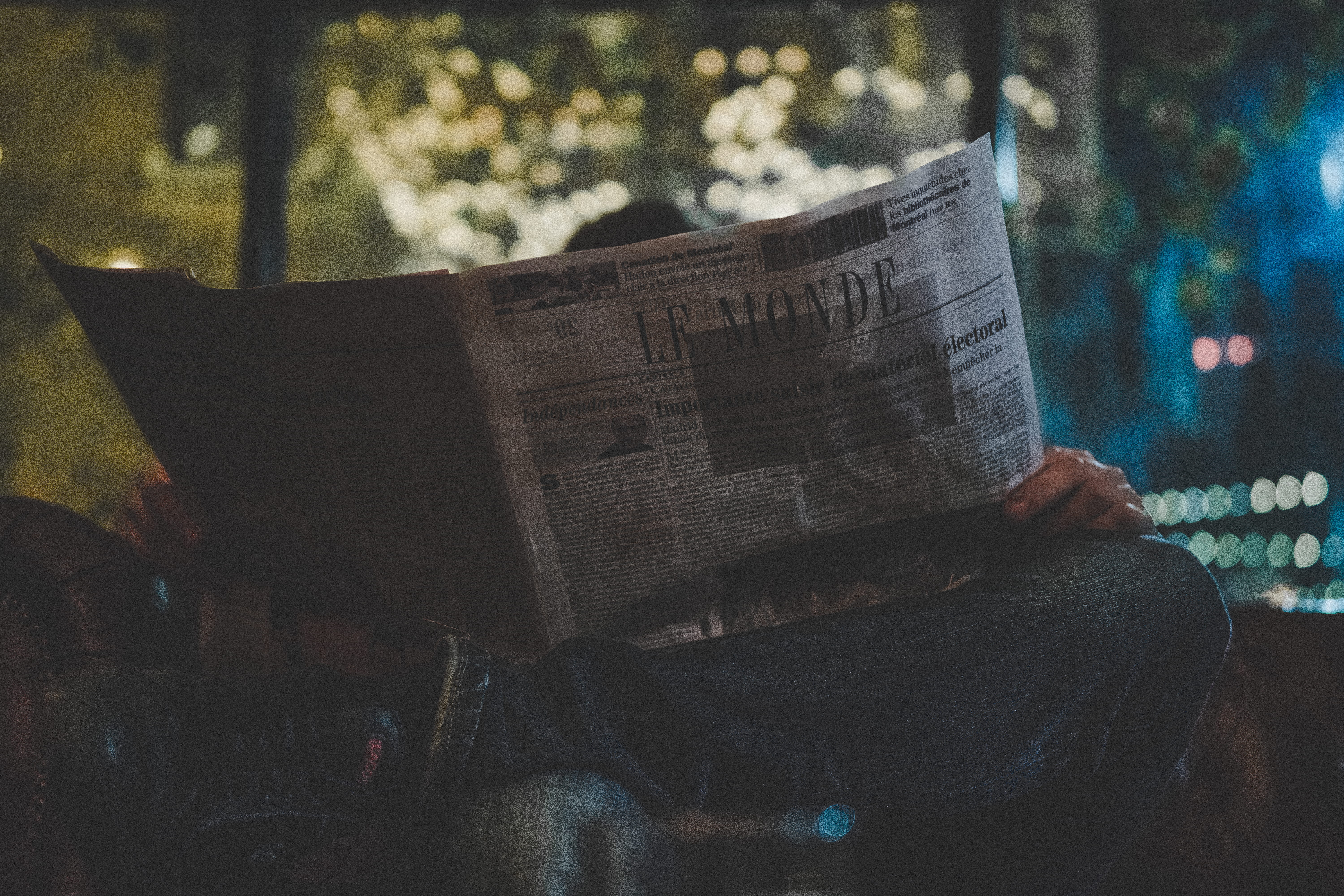 bokeh, men, one person, night, blade, reading, start, le monde, sitting, starwar, read, neon light, communication, jeans, western script, activity, the media, HD Wallpaper