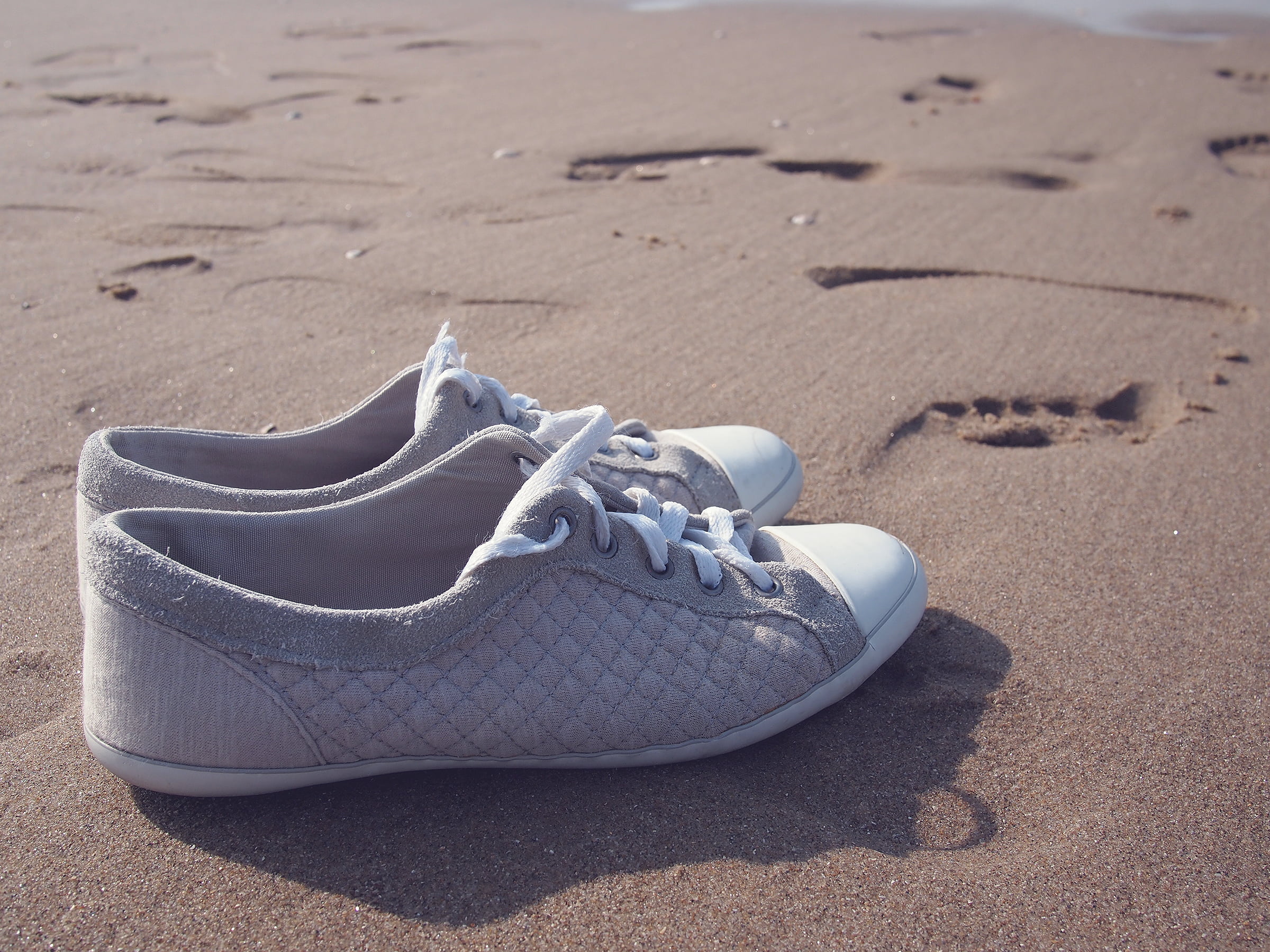 daytime, close-up, low, sand, nature, absence, tops, no people, white, shoe, pair, gray, top, compatibility, personal accessory, water, outdoors, 1080P, HD Wallpaper