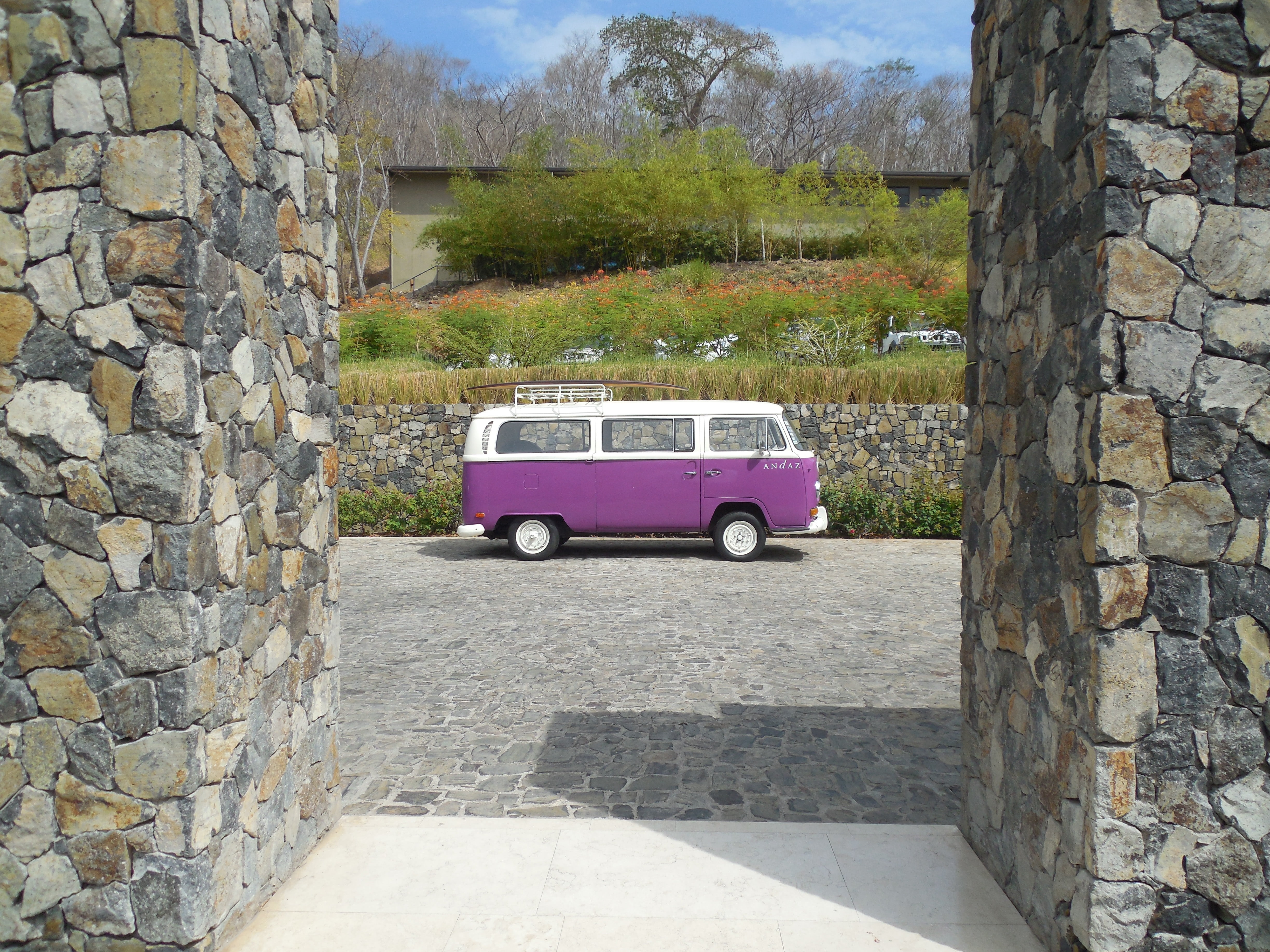 sunlight, solid, wall, flowers, car, plant, tree, nature, architecture, purple, stone, t, concrete, motor vehicle, van, parked, outdoors, travel, 4K, built structure, HD Wallpaper