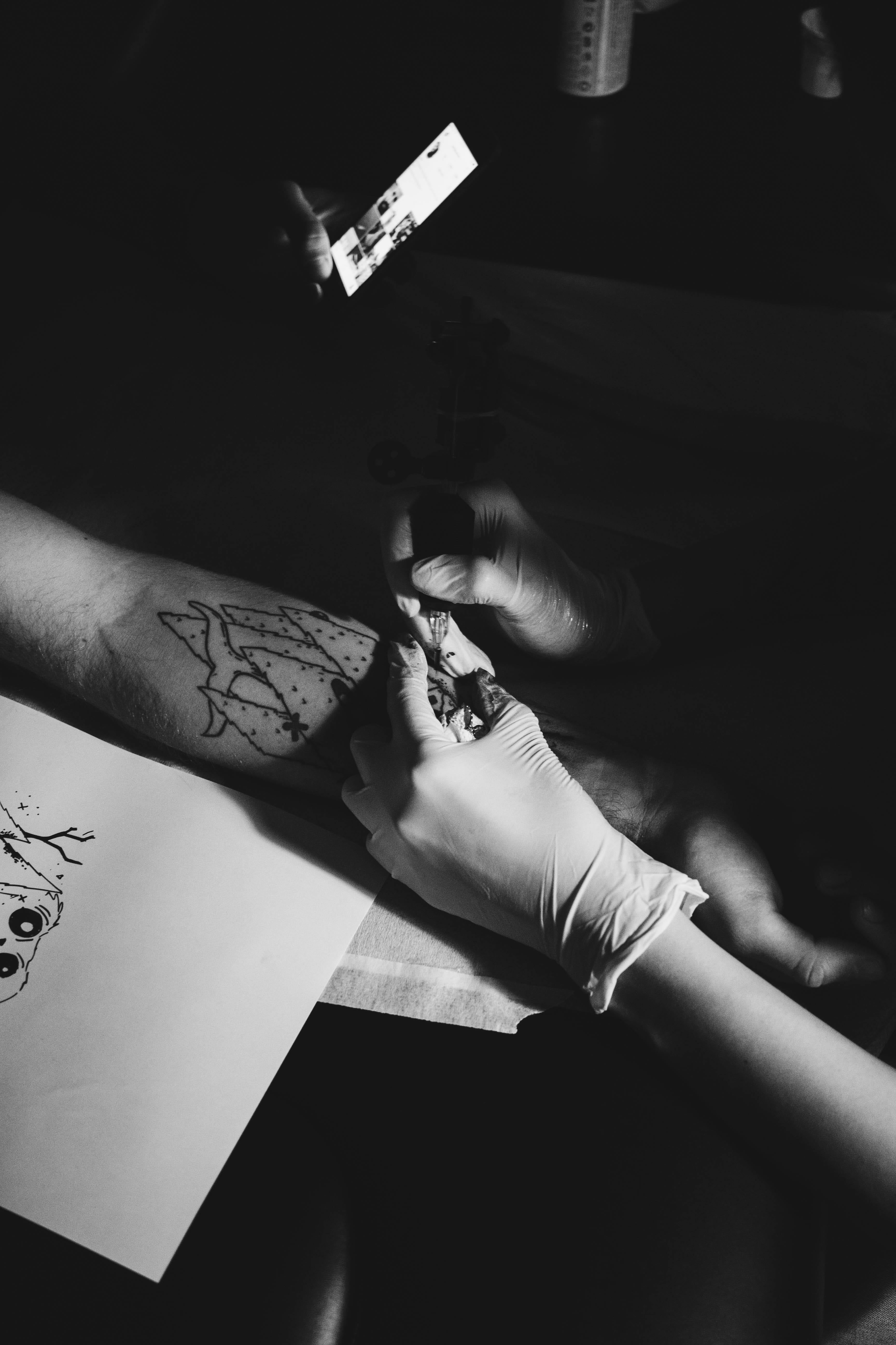 black-and-white, lifestyles, indoors, activity, hand, high angle view, creativity, tattoo, art and craft, holding, paper, occupation, human limb, working, Phone HD Wallpaper