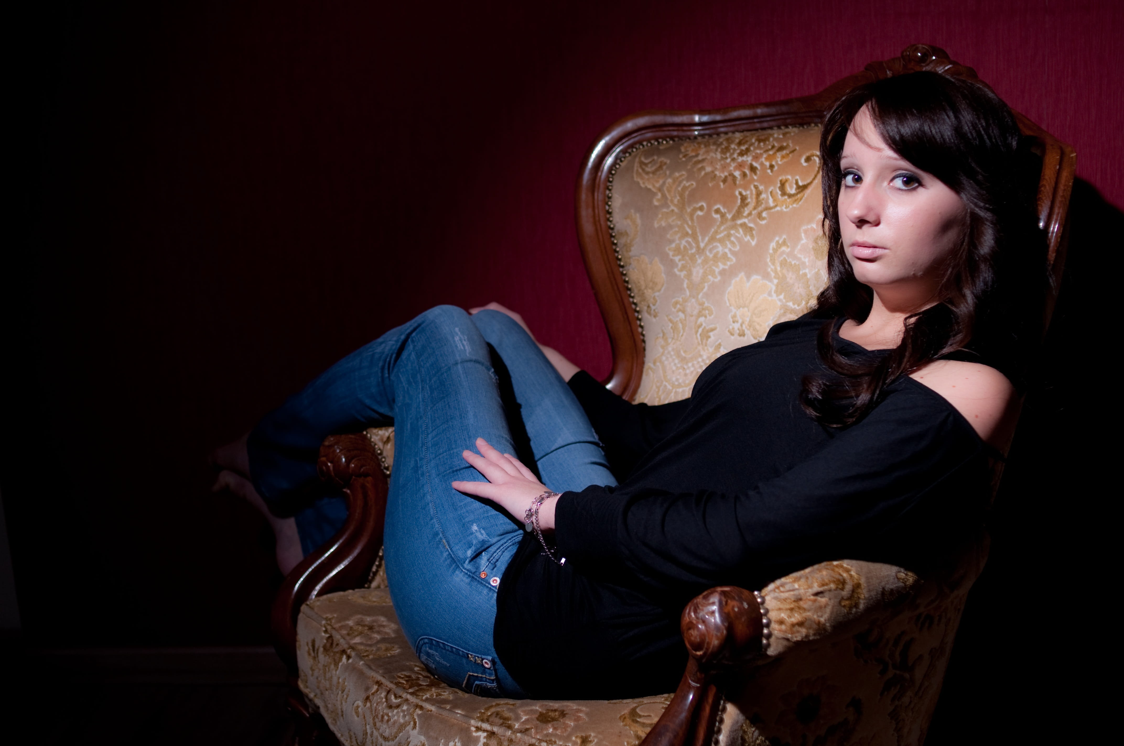 face, contemplation, beautiful, three quarter length, real people, long hair, young adult, looking at camera, pretty, indoors, portrait, chair, red background, HD Wallpaper
