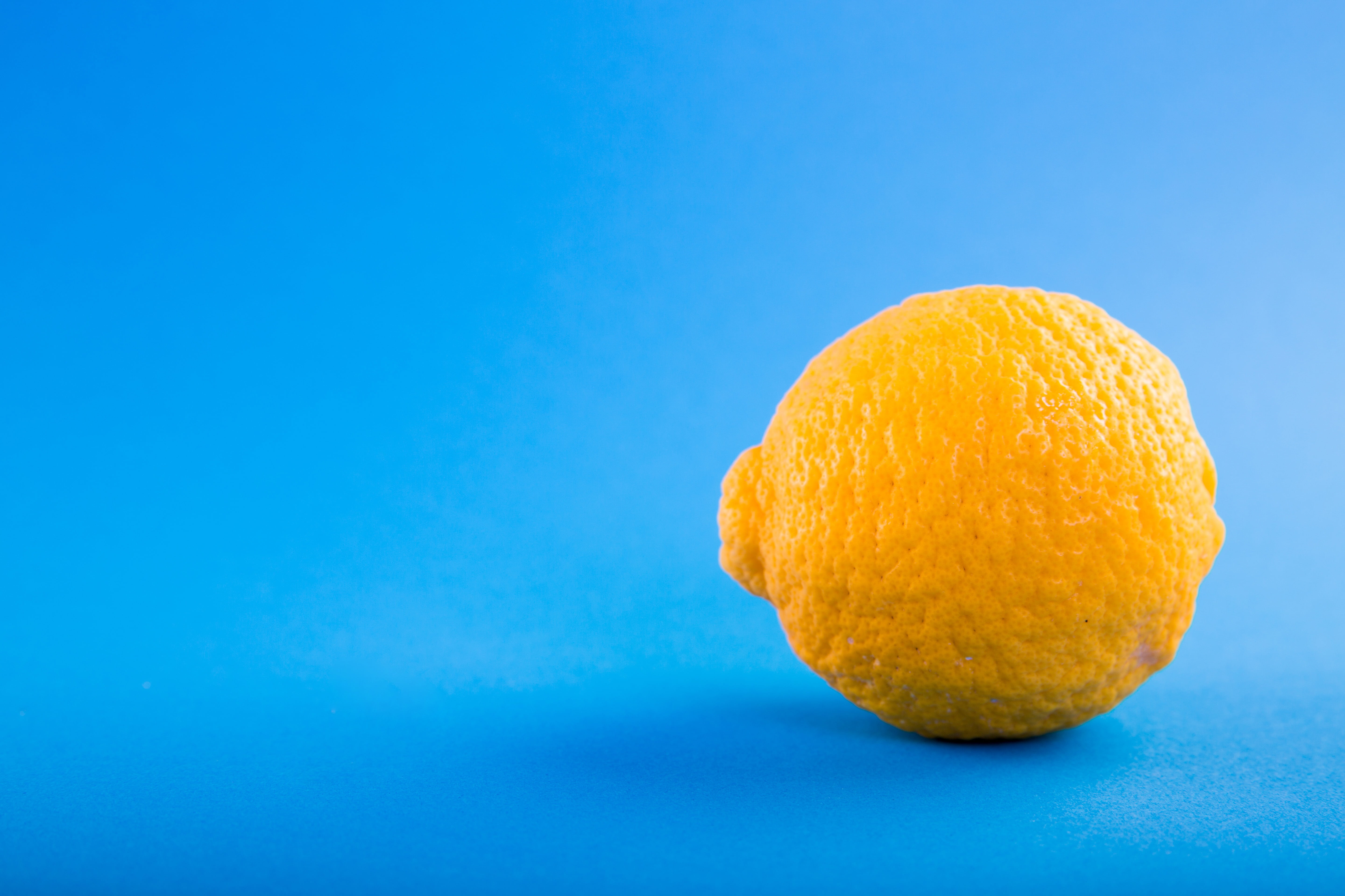 yellow, orange, colored background, food, still life, citrus, acid, blue, copy space, lime, simplicity, indoors, orange color, studio shot, bitter, single object, HD Wallpaper