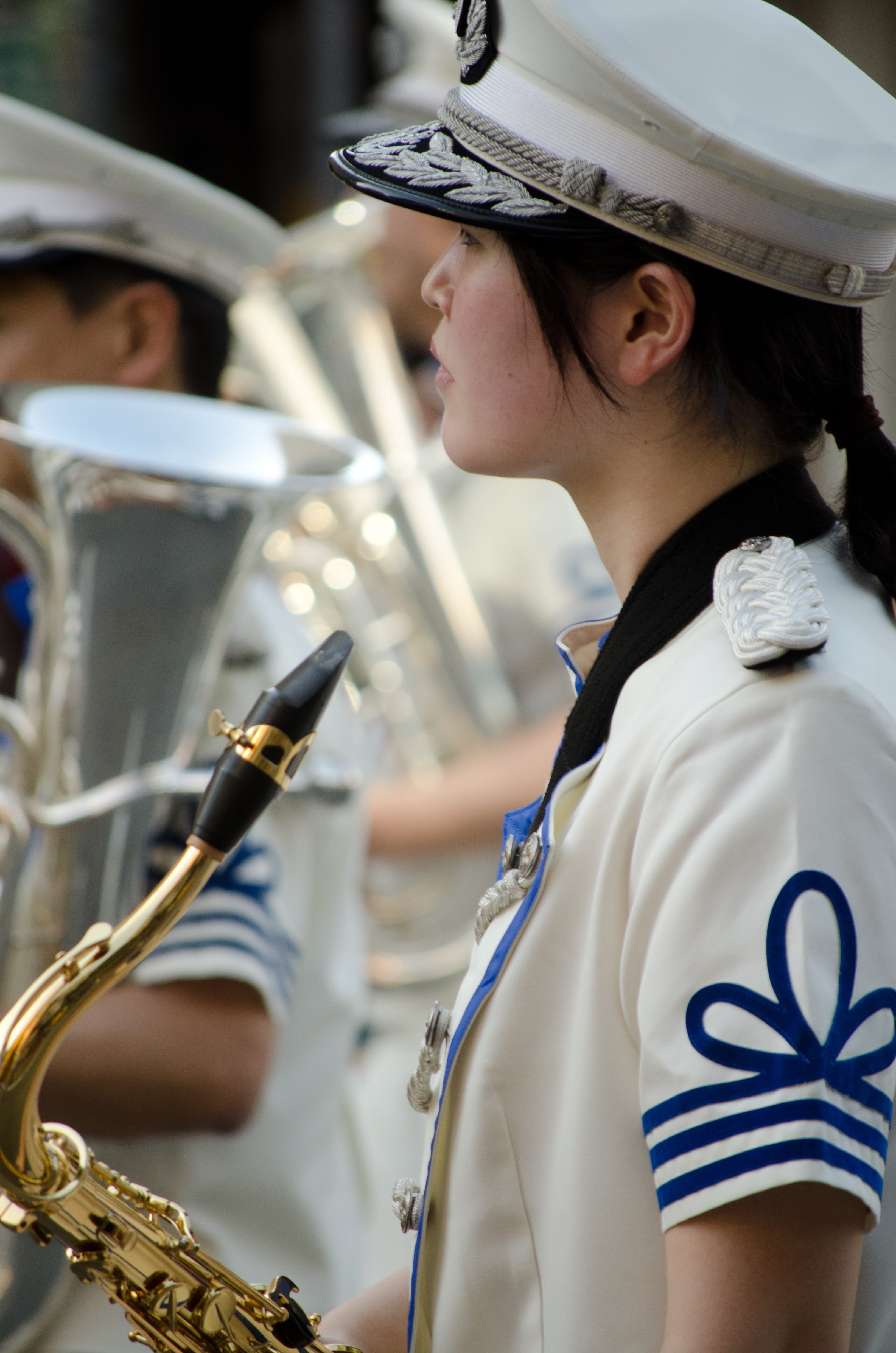 focus on foreground, woman, marching band, headwear, event, kobe, holding, uniform, Band, selective, saxophone, skill, occupation, young adult, portrait, Phone HD Wallpaper