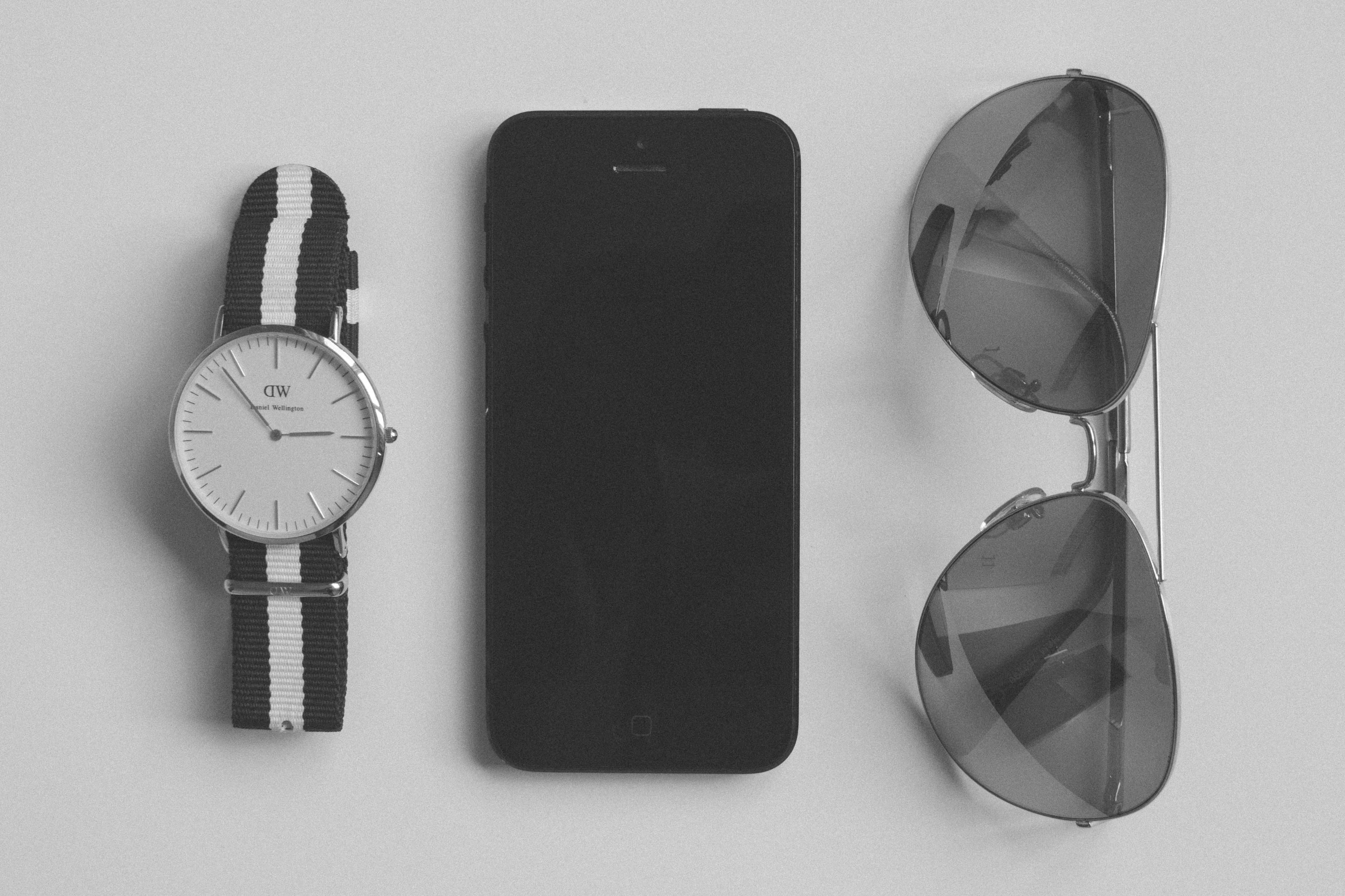 black and white, iphone, smart phone, black, mobile, silver, no people, indoors, group of objects, table, accessories, sunglasses, personal accessory, clock, HD Wallpaper