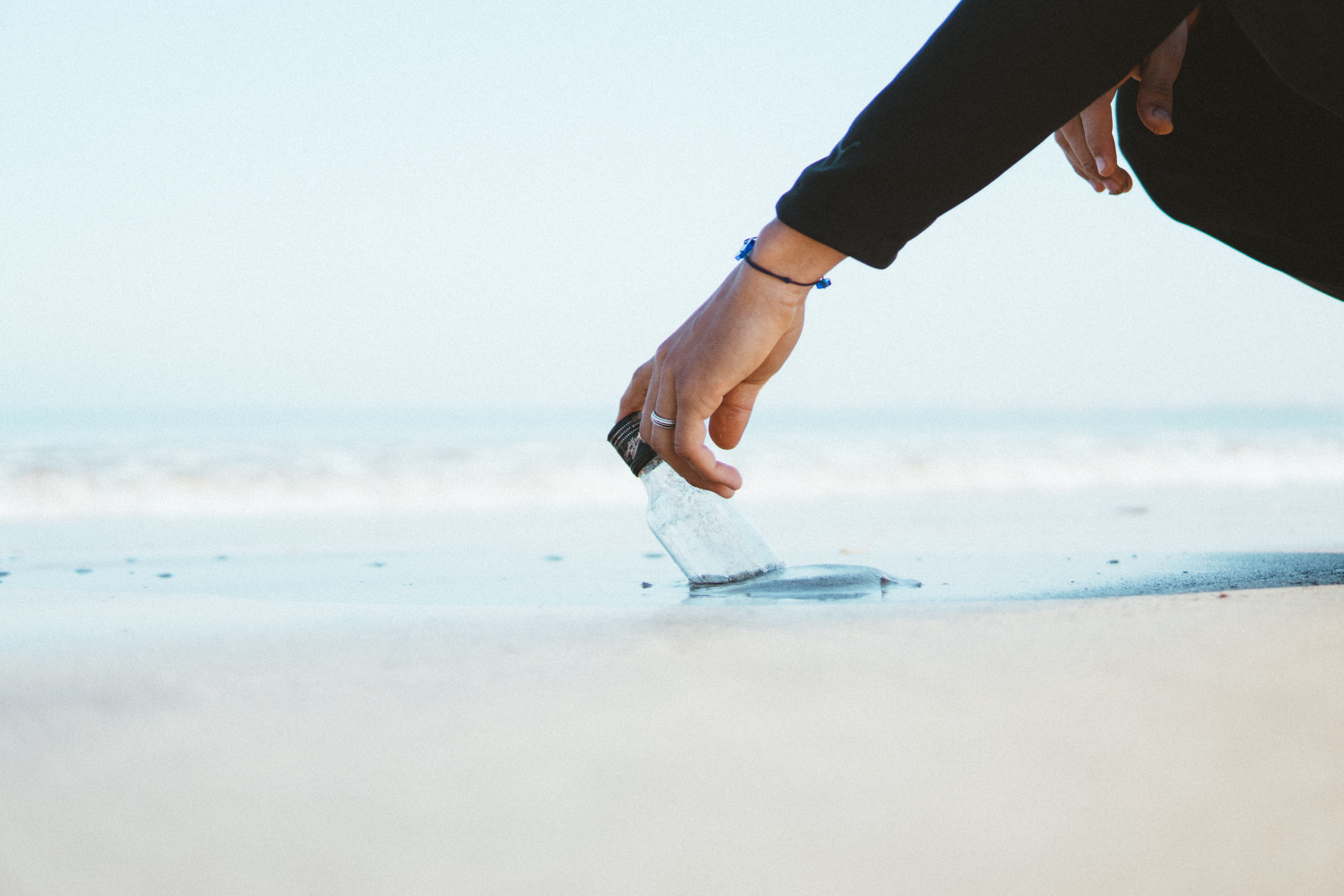 wearing, bottle, sea, holding, person, 4K, top, nature, seashore, sky, color, water, horizon, day, action, human body part, beach, land, sleeved, black, HD Wallpaper