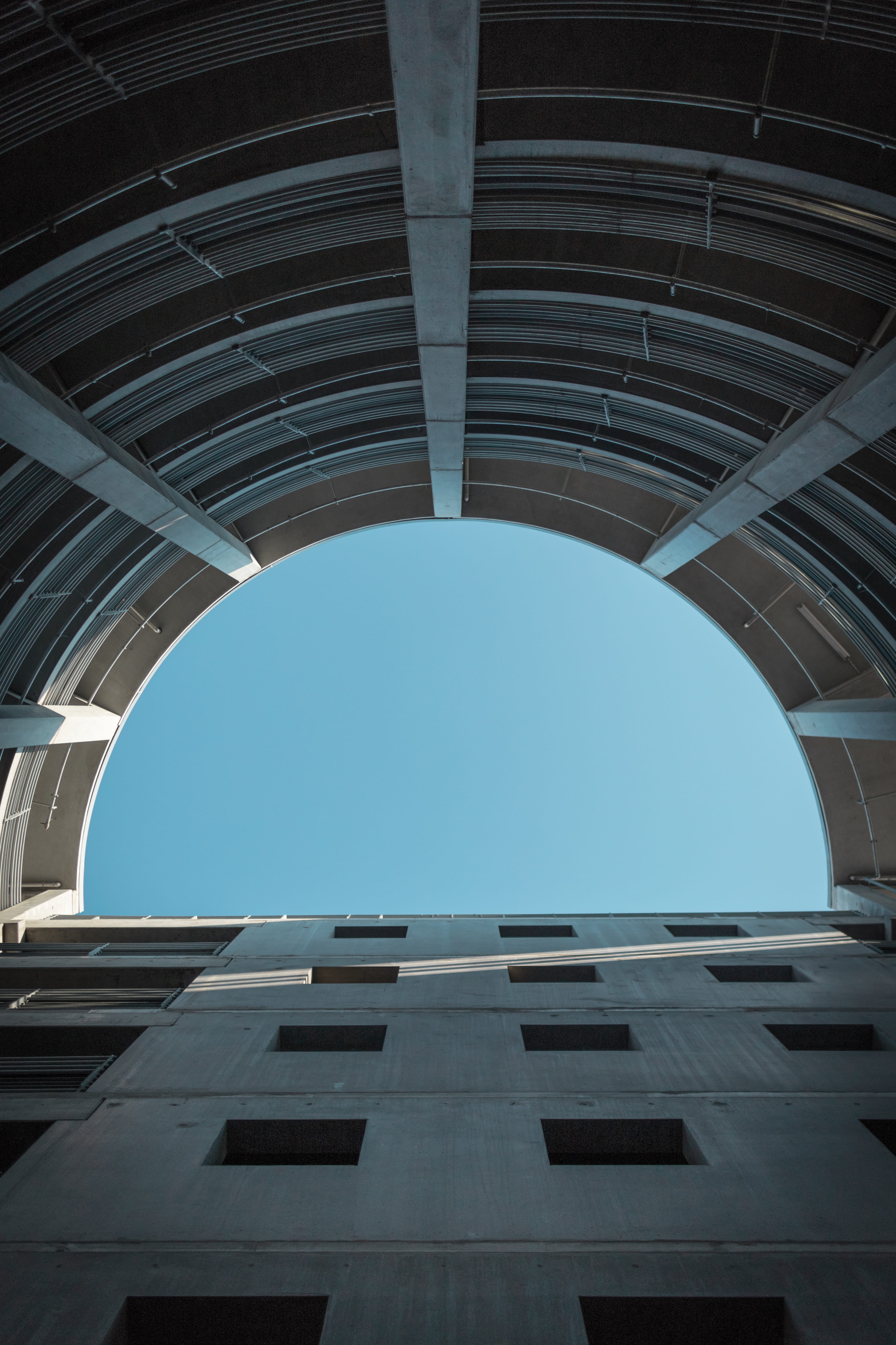 bluesky, city, building exterior, low angle view, no people, light at the end of the tunnel, built structure, modern, sunlight, carpark, copenhagen, sky, Phone HD Wallpaper