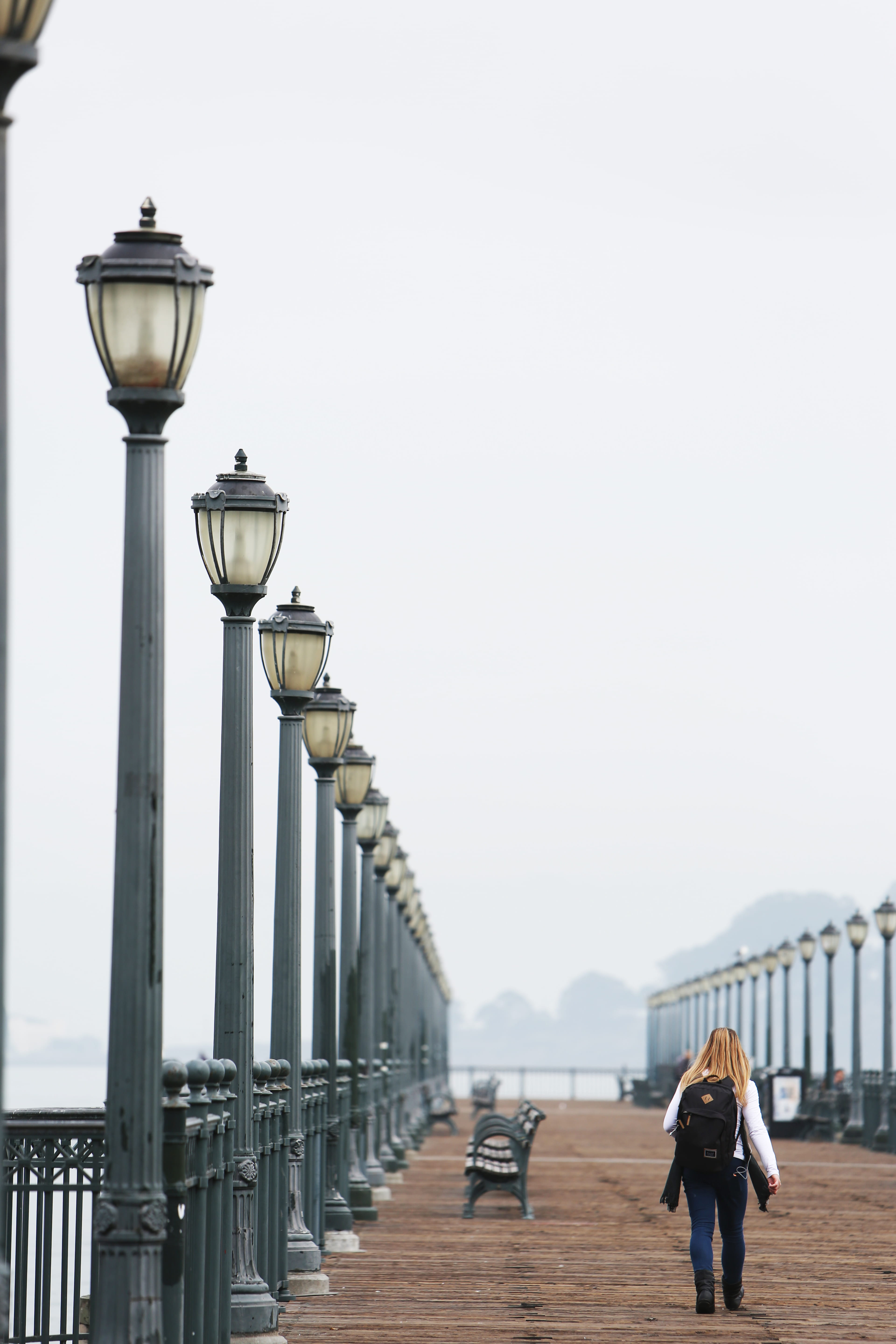 lifestyles, built structure, adult, lights, railing, architecture, peer, outdoors, activity, the way forward, direction, poles, walking, street, metal, Phone HD Wallpaper