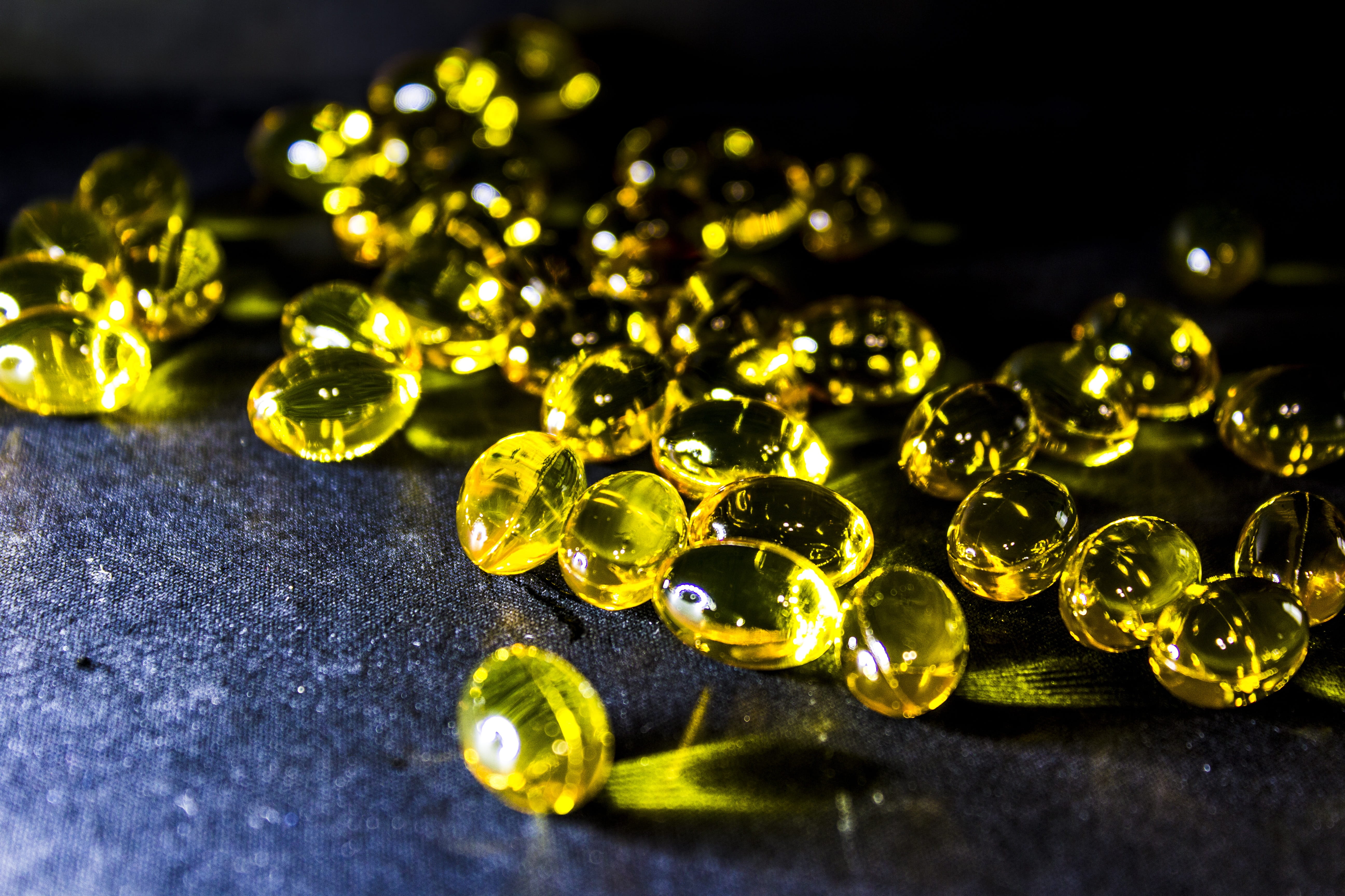 vitamins, no people, 5K, macro, selective focus, indoors, fat fish, marbles, gold colored, still life, art and craft, close-up, food, nature, gemstone, HD Wallpaper