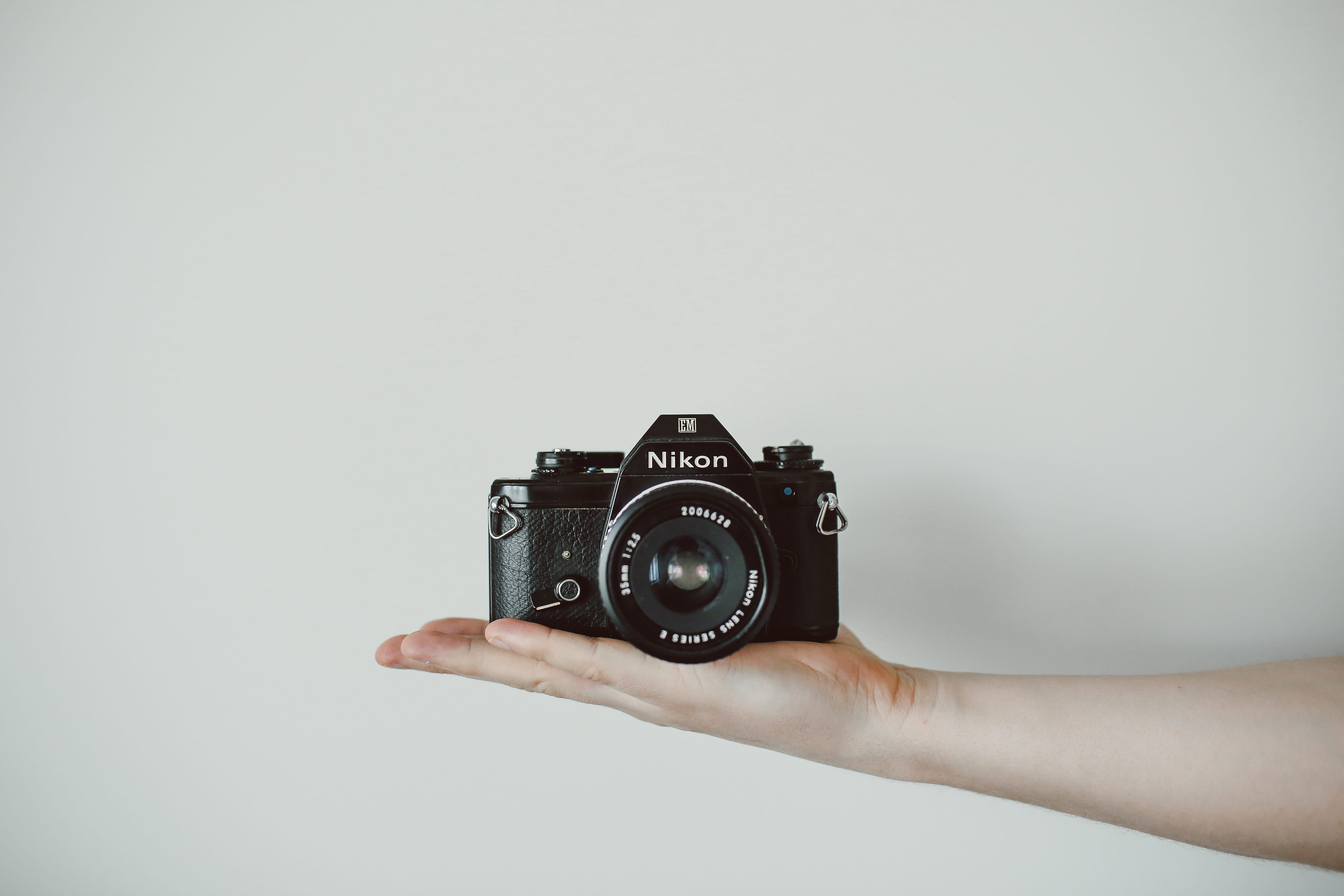 photograph, black, photographing, antique, human Hand, old, hand, human limb, arm, photographic equipment, camera, gray background, 5K, Nikon, holding, HD Wallpaper