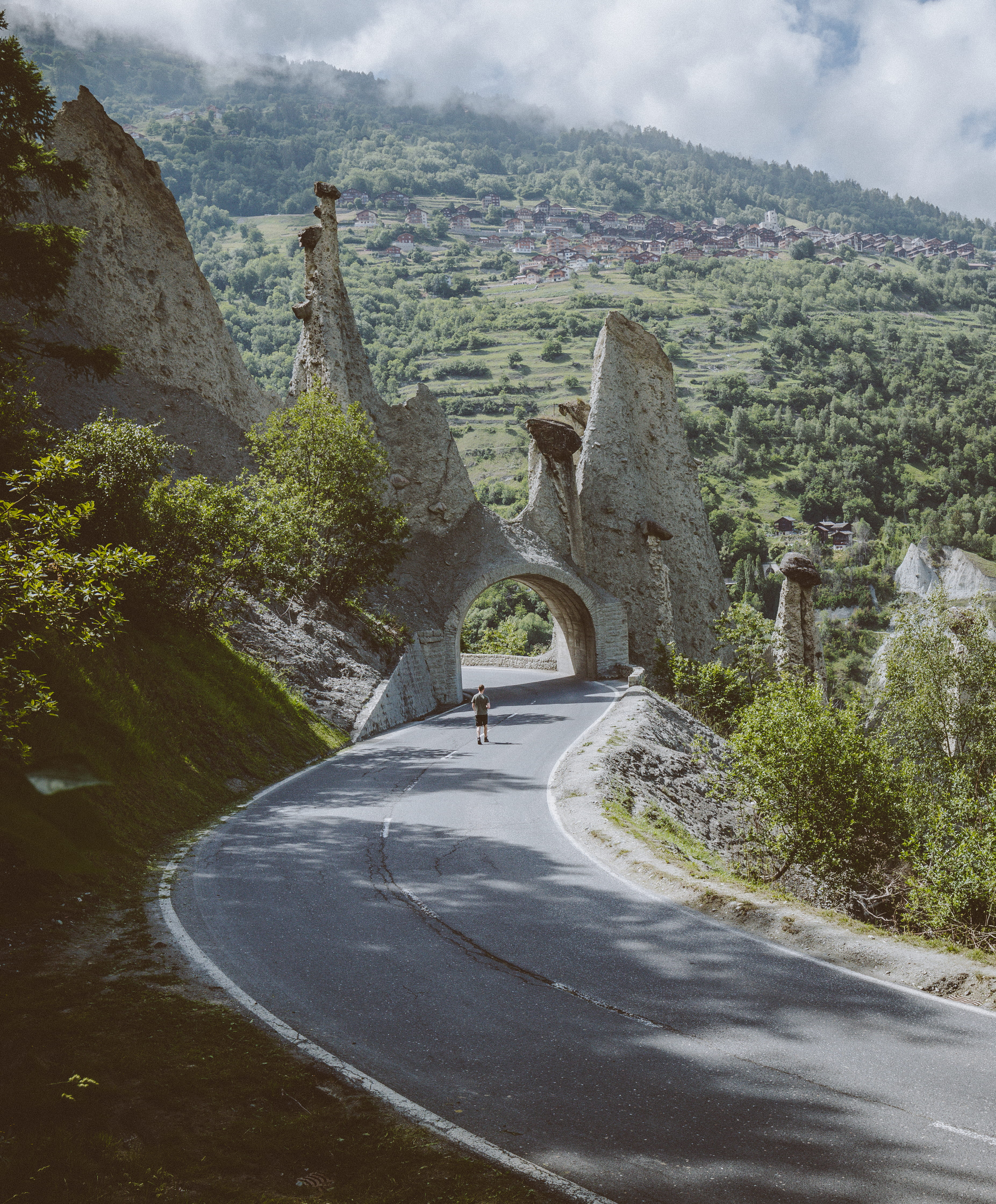 outdoors, tunnel, mountain, day, adventure, standing, guy, walking, road, plant, near, beauty in nature, no people, the way forward, nature, direction, Phone HD Wallpaper