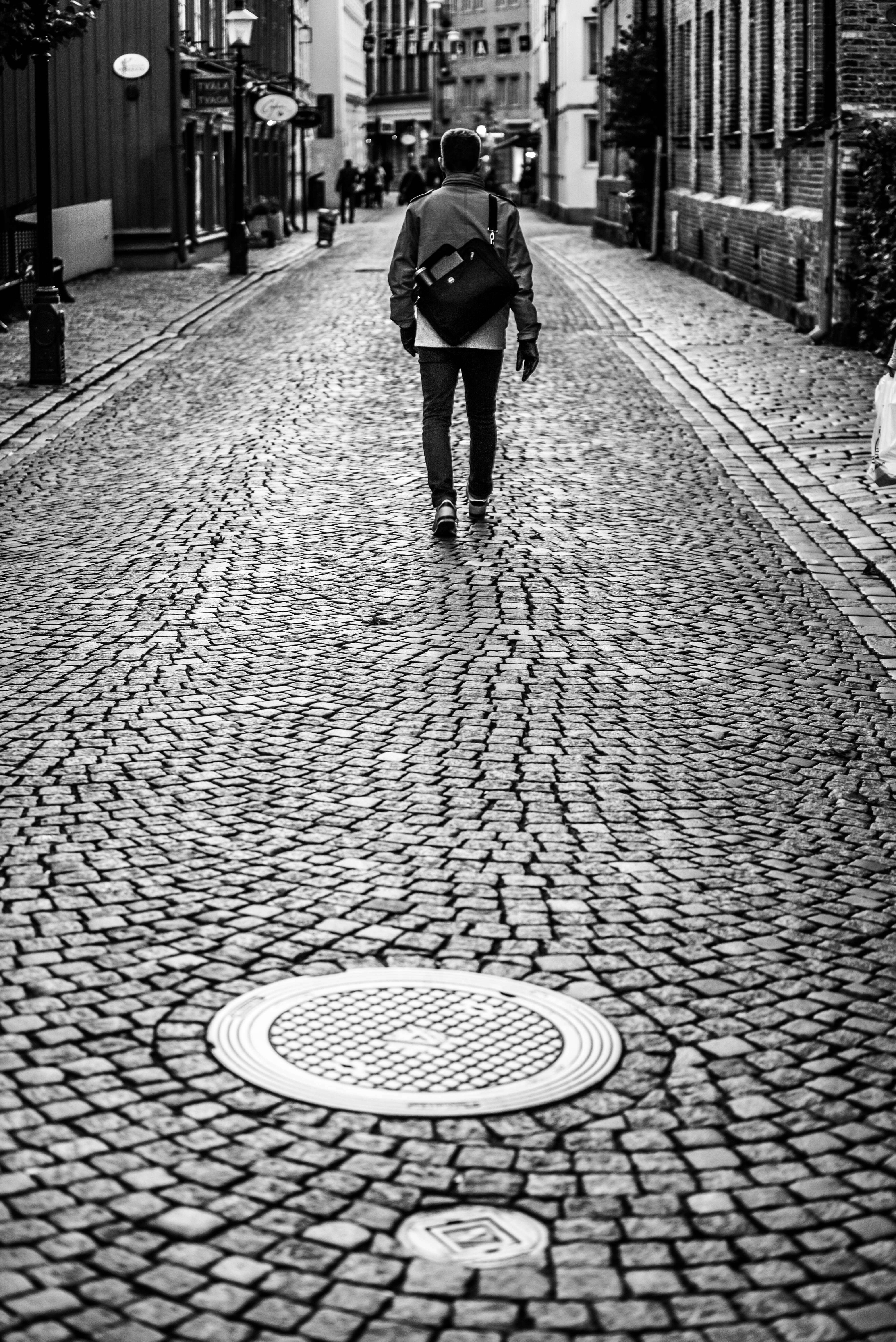 people, pattern, day, pedestrians, outdoors, manhole, one person, alley, urban Scene, cobblestone, 5K, black And White, real people, walking, the way forward, Phone HD Wallpaper