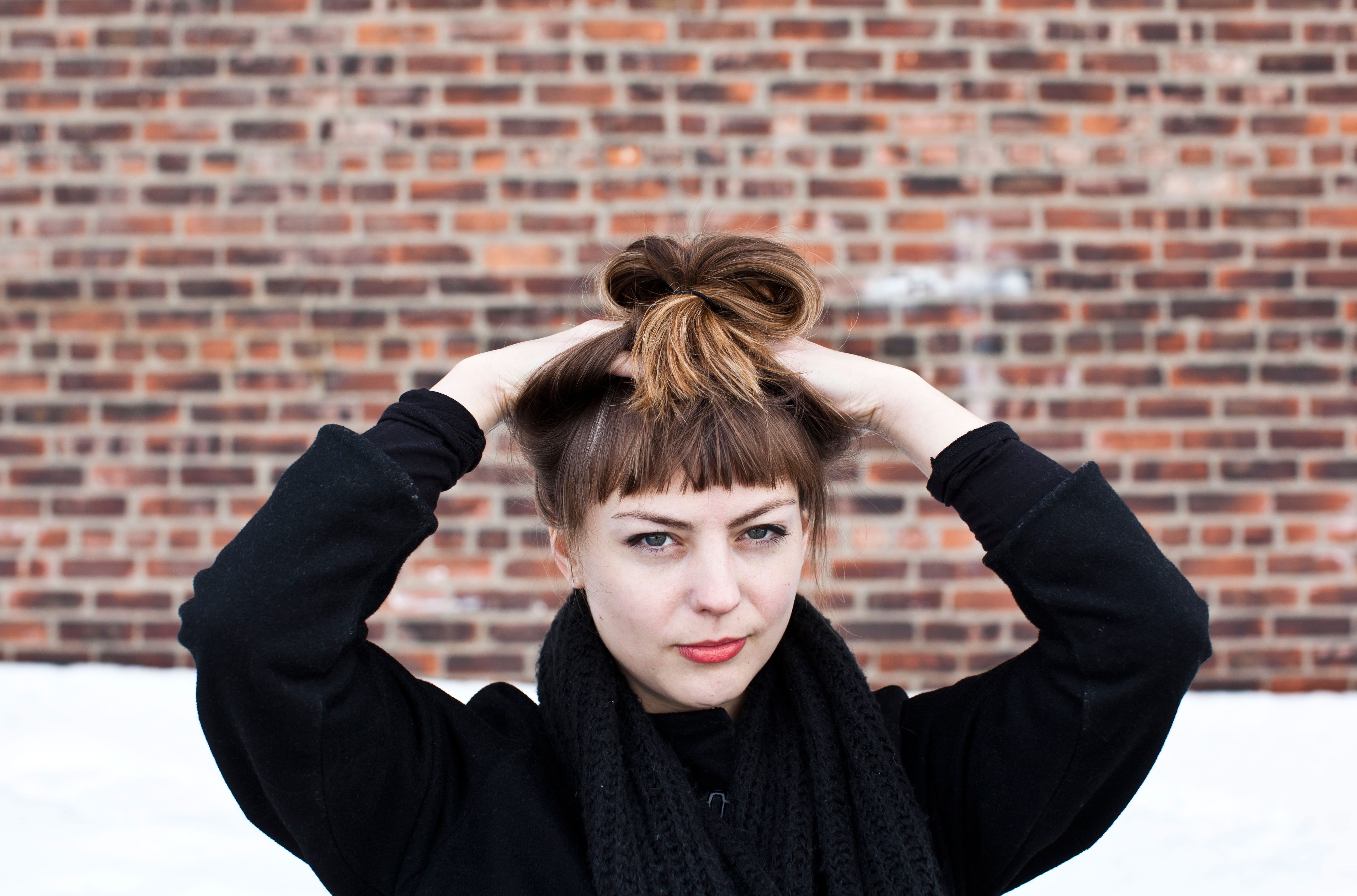 looking at camera, human arm, headshot, arms raised, lifestyles, hairstyle, real people, women outdoors, bricks, Angel Olsen, young adult, front view, musician, HD Wallpaper