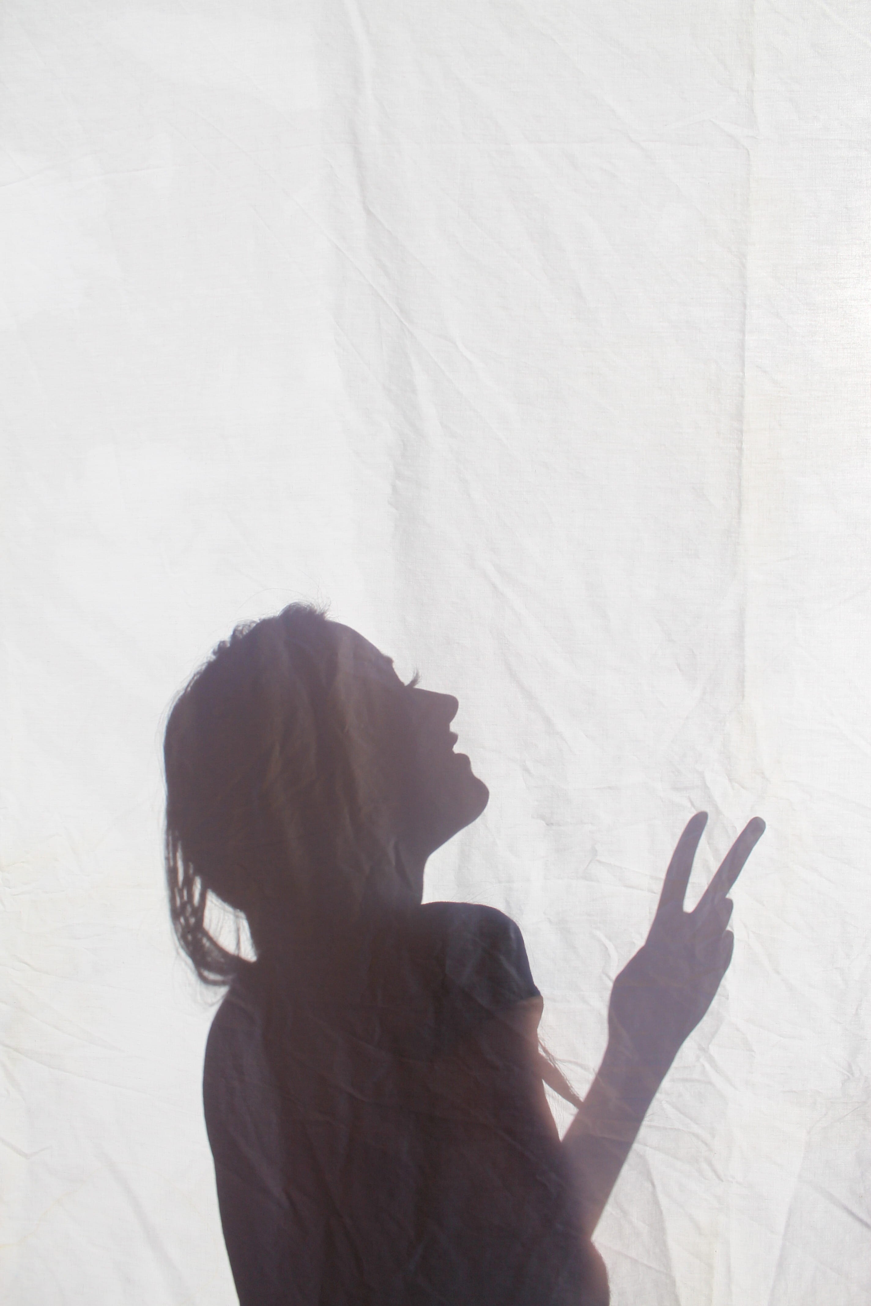leisure activity, pacifist, spirit, indoors, 4K, woman, no war, side view, peace, real people, women, sign, day, gesturing, one person, hippy, shadow, Phone HD Wallpaper