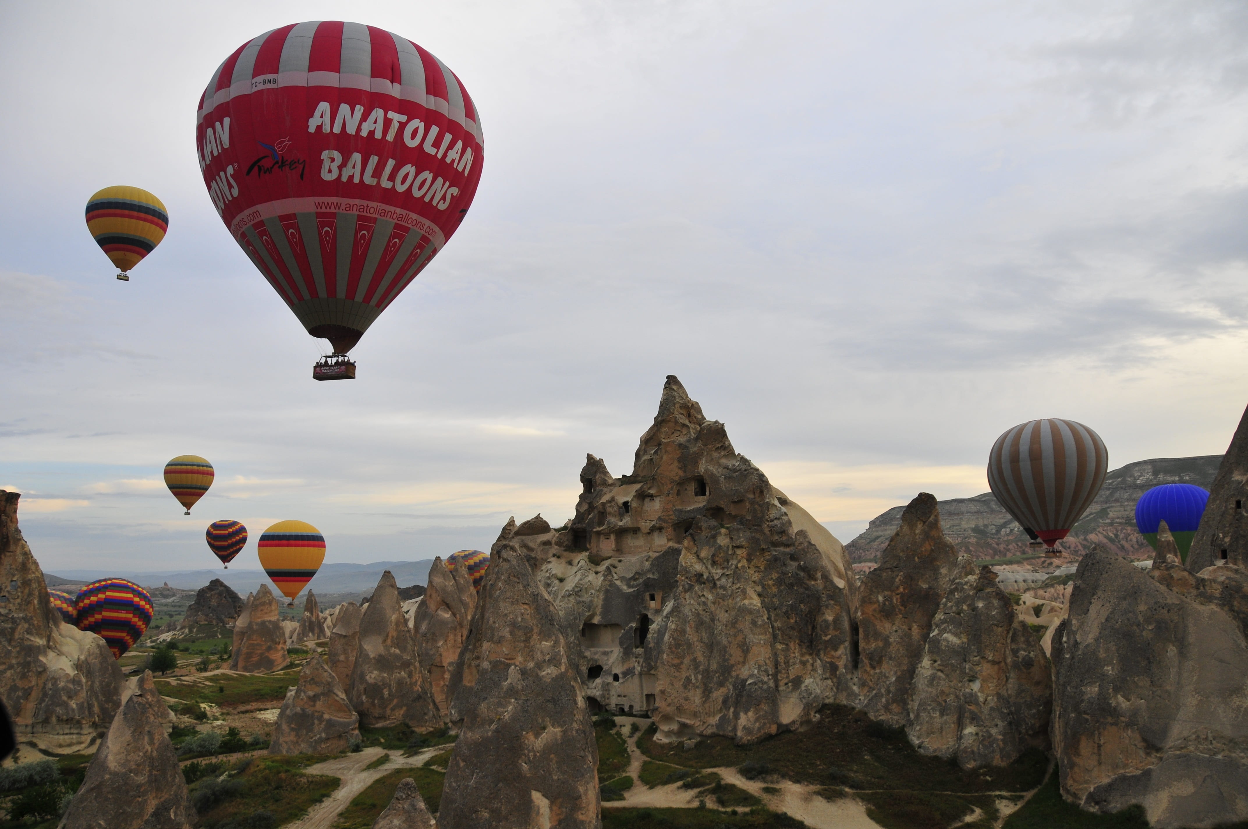 rock, nature, hot air balloon, mid-air, travel, cloudy, architecture, summer, spring, built structure, air vehicle, clouds, outdoors, yellow, flying, horse, HD Wallpaper