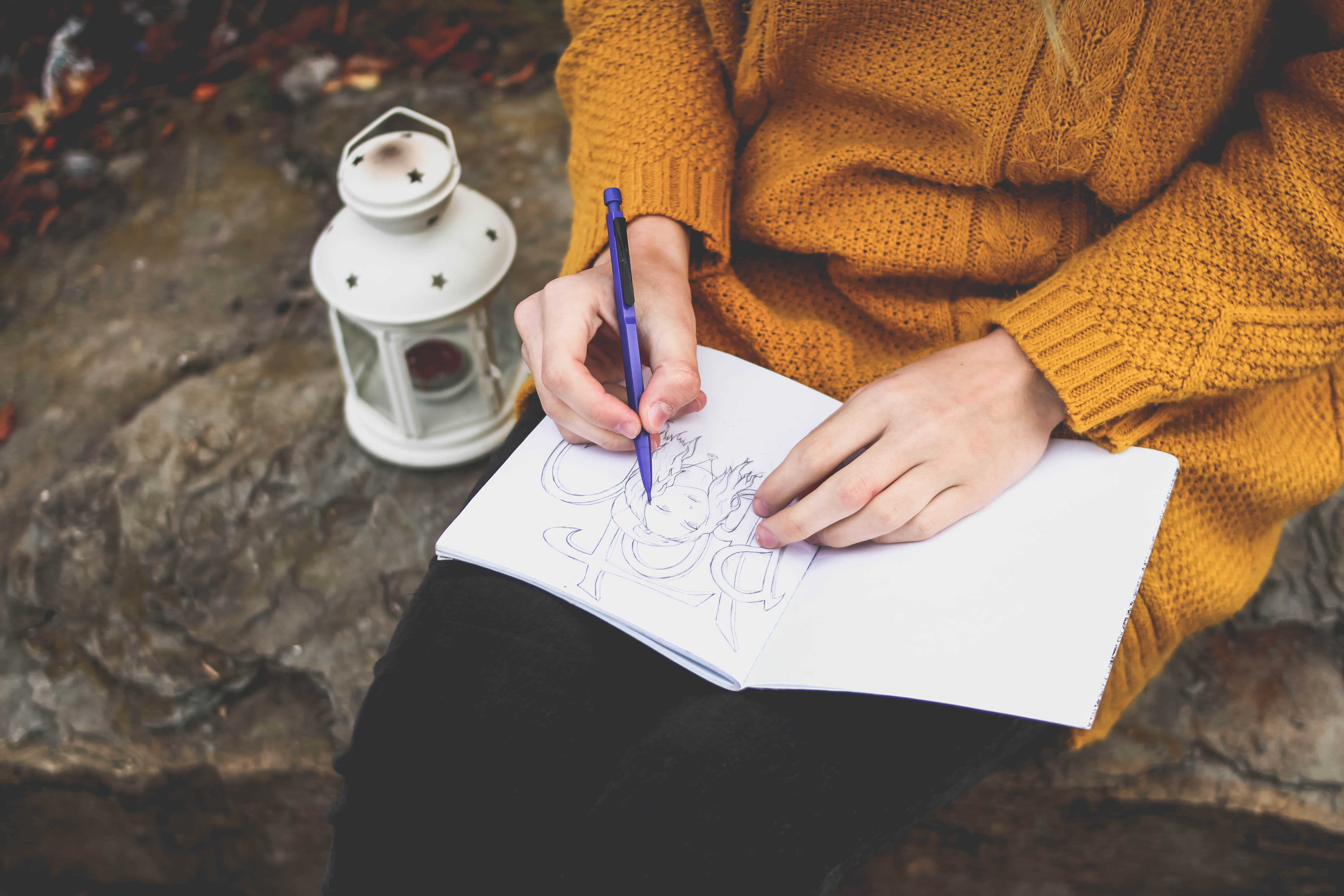 holding, book, one person, art and craft, sitting, solid, craft, sweater, white, person, midsection, lantern, creativity, drawing, paper, 5K, skill, art, HD Wallpaper