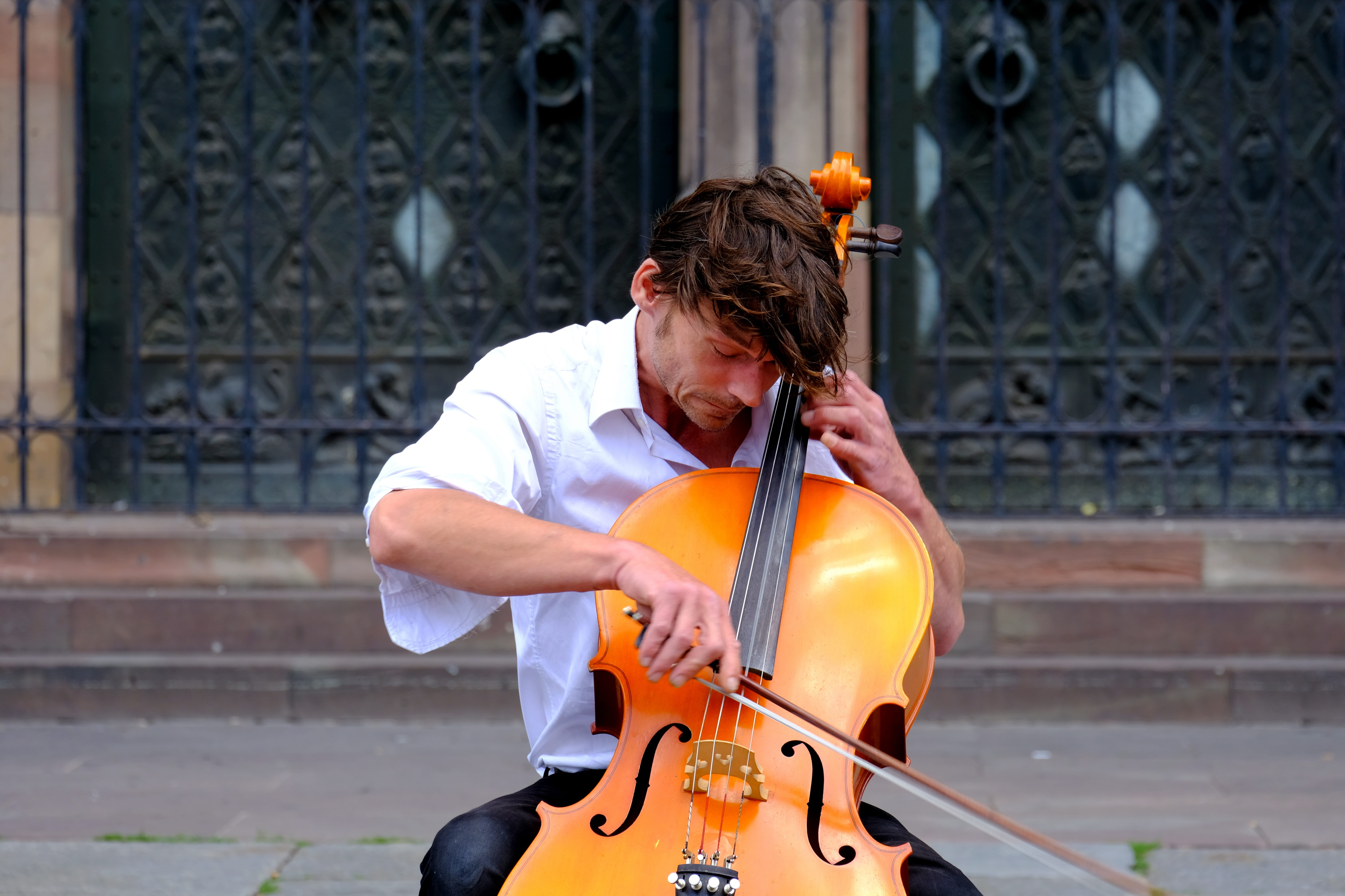 cathedral, 5K, real people, piece of music, street music, movement, performer, building exterior, hand attitude, leisure, cello, warm, street performer, HD Wallpaper