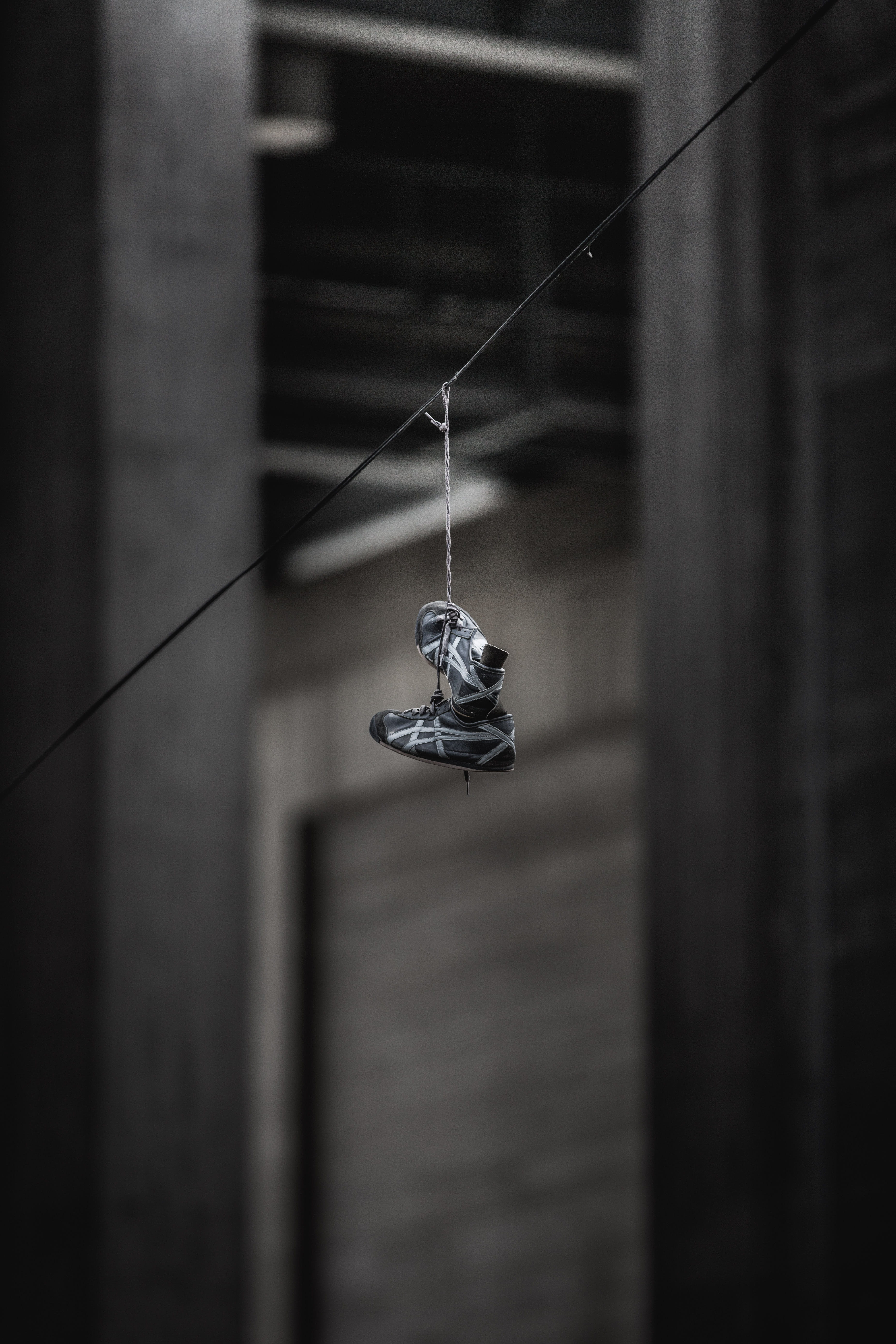 day, 5K, selective focus, close-up, sneaker, shoe, lighting equipment, pair, no people, asics, building, white, urban, ceiling, hanging, street, wall - building feature, Phone HD Wallpaper