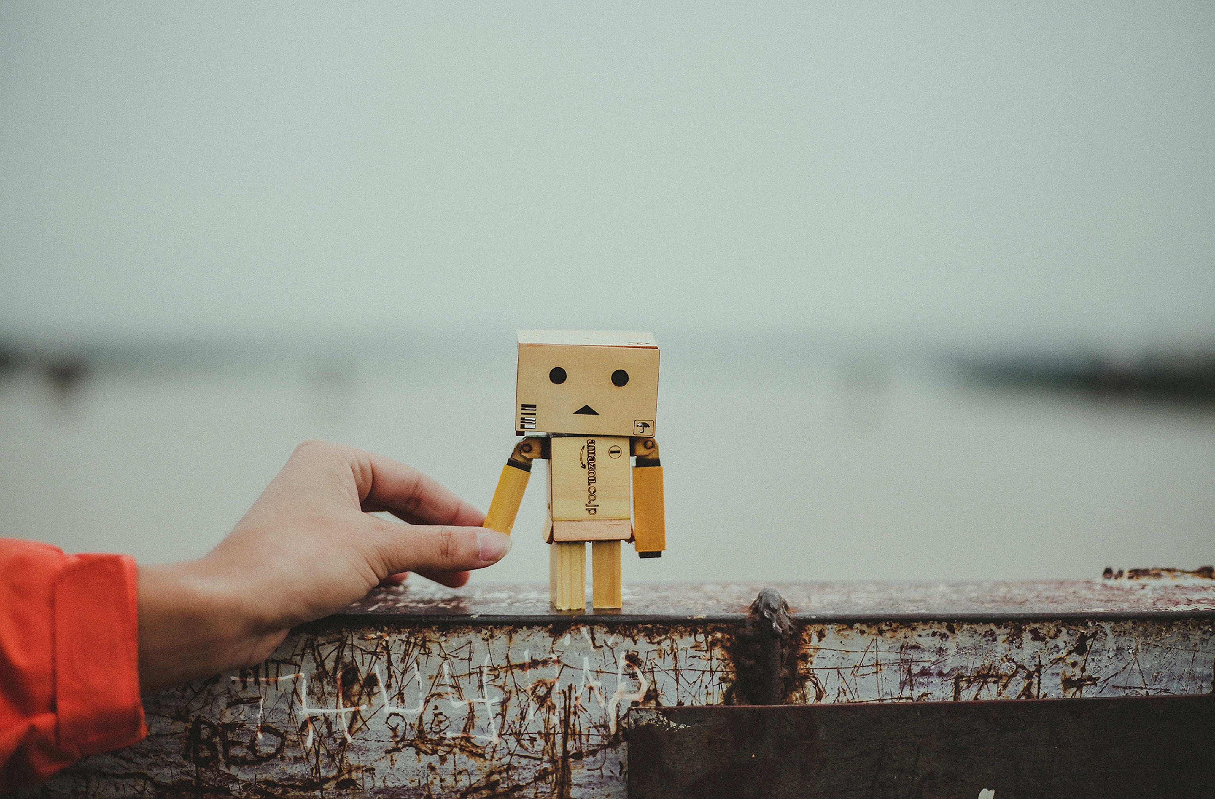 4K, unrecognizable person, human Hand, water, cardboard robot, finger, lifestyles, day, toy, friendship, body part, men, ideas, human finger, focus on foreground, HD Wallpaper