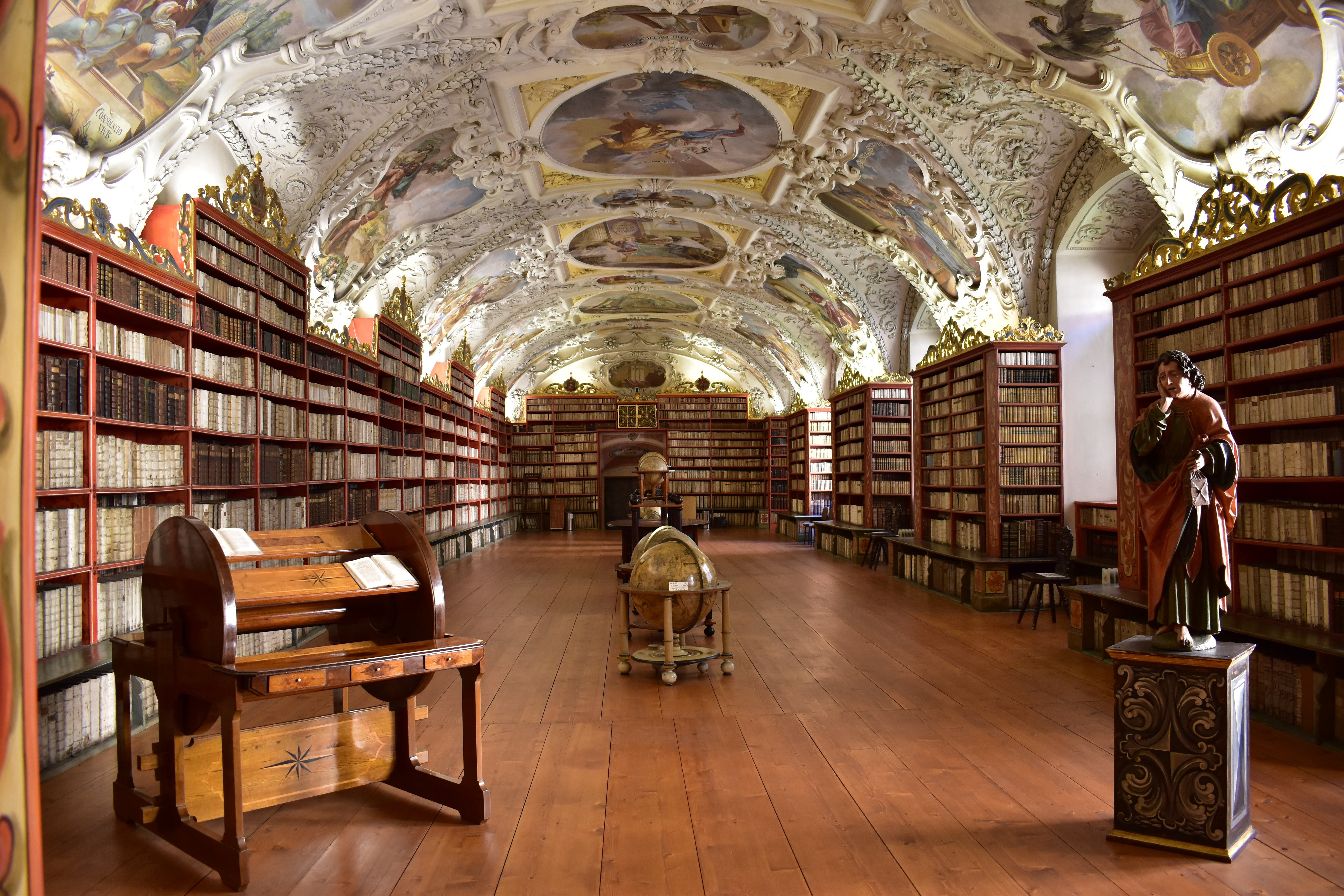 bookshelf, statue, globe, wooden, religion, prague, large group of objects, human representation, architecture, seat, desk, brown, sculpture, book, education, HD Wallpaper