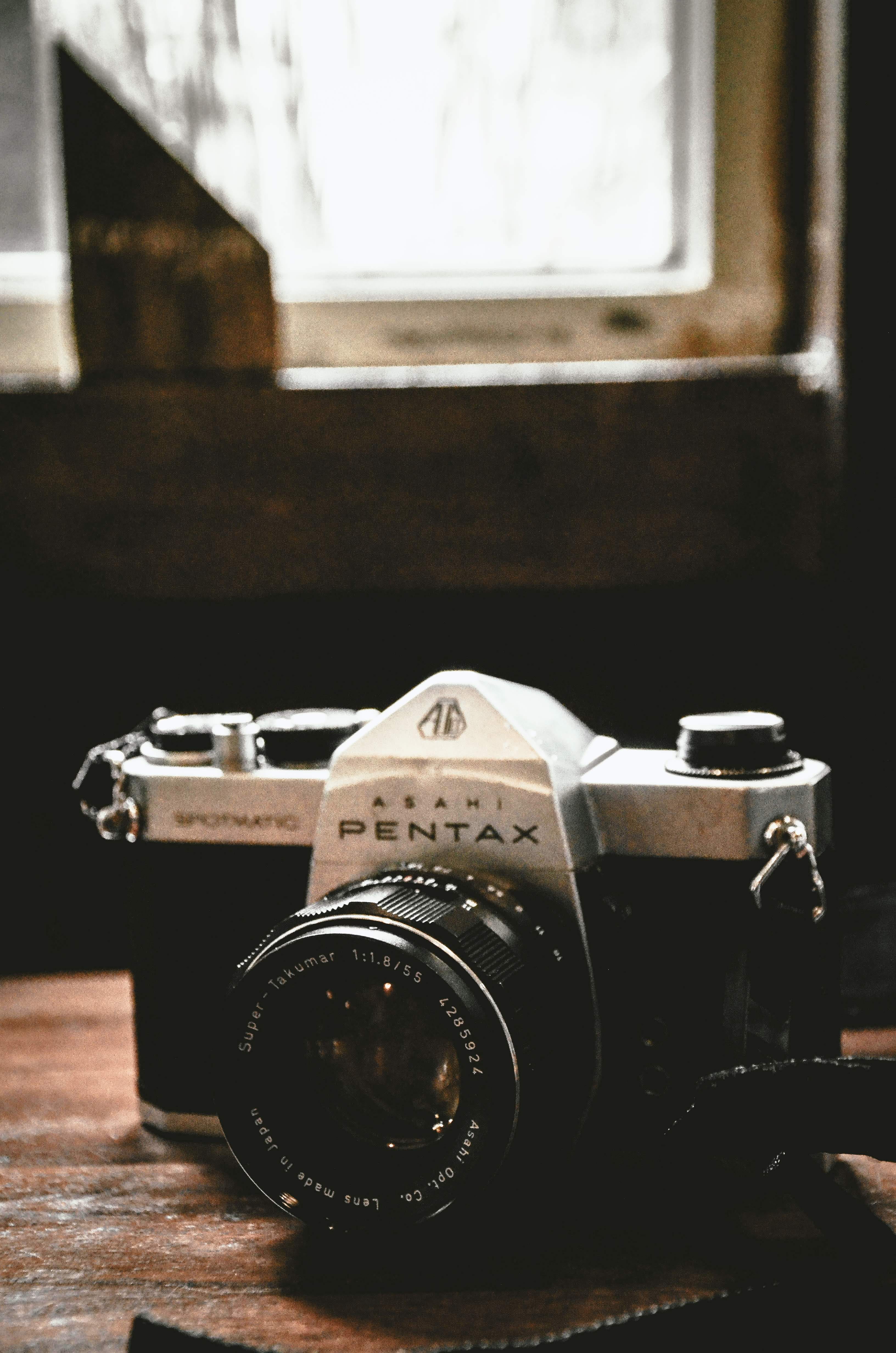 table, close-up, photographic equipment, pentax, classic, camera, selective focus, strap, photography themes, manimalist, shelf, technology, film grain, Phone HD Wallpaper