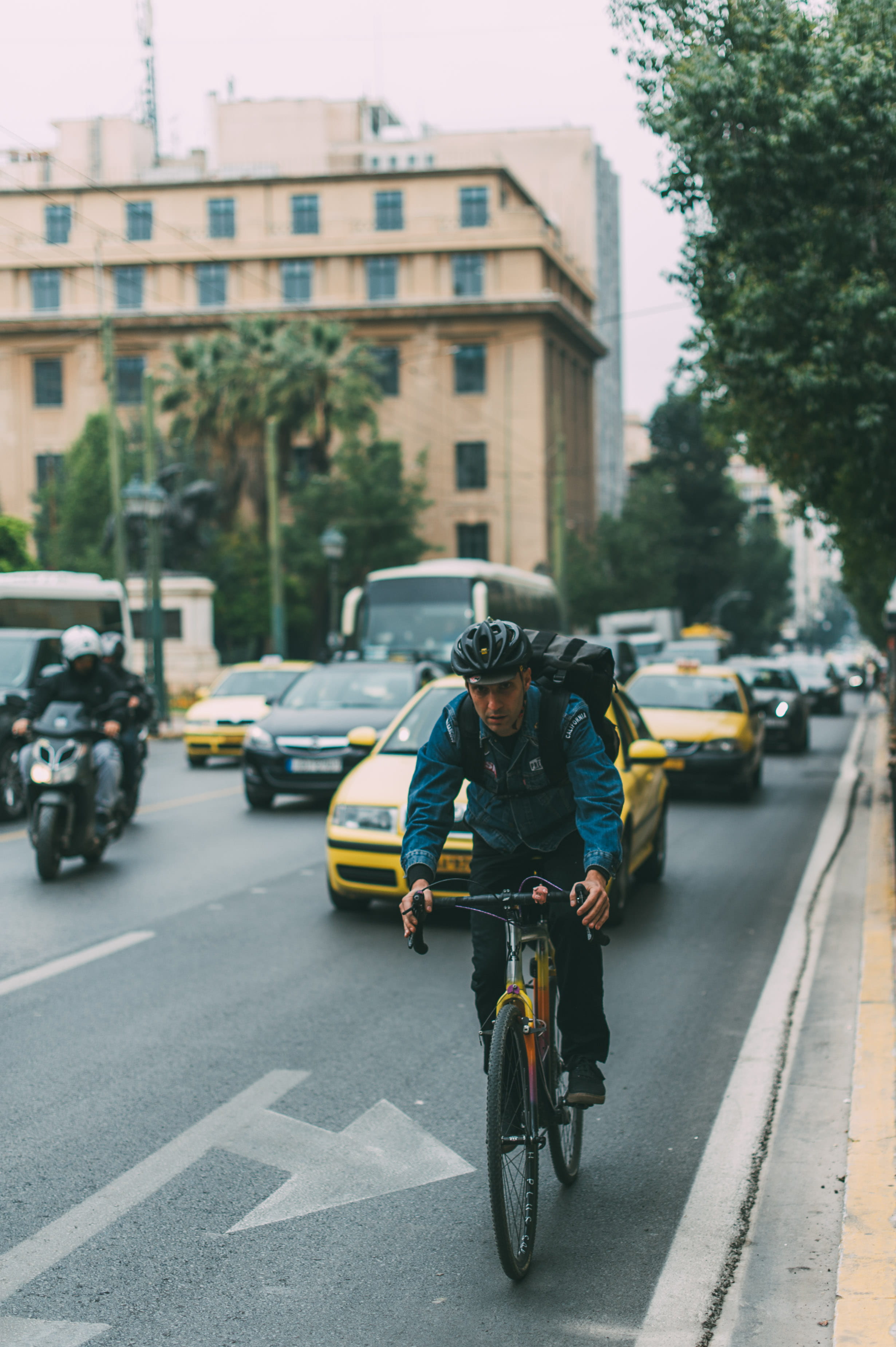 cycling, 2K, building exterior, built structure, road, biking, bike, motorcycle, tree, riding, one person, man, road marking, cars, bicycle, travel, motor vehicle, Phone HD Wallpaper