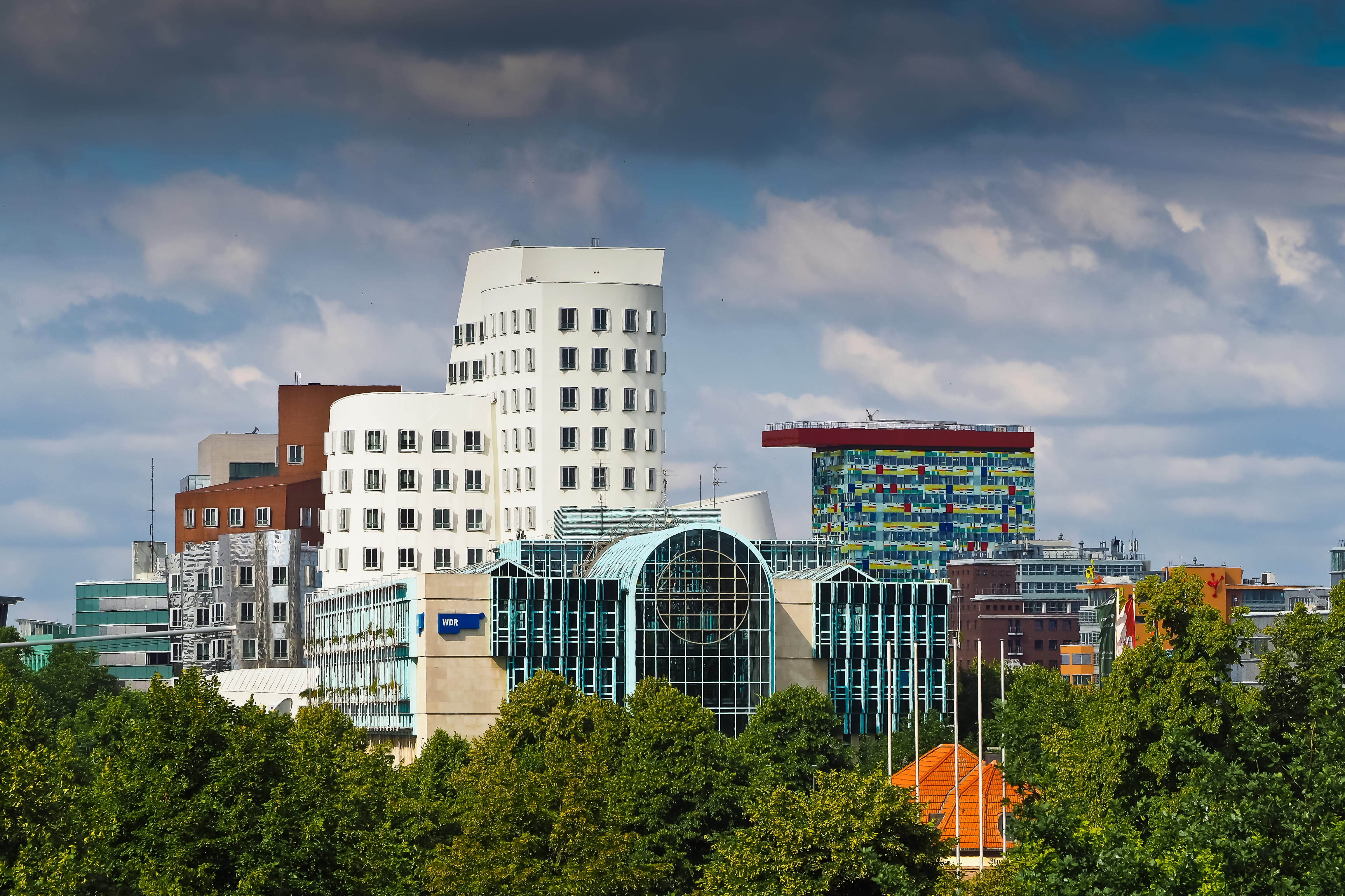 urban Scene, gehry, urban Skyline, modern architecture, no people, built Structure, nature, day, hauswand, bowever, dark clouds, tree, outdoors, media harbour, HD Wallpaper