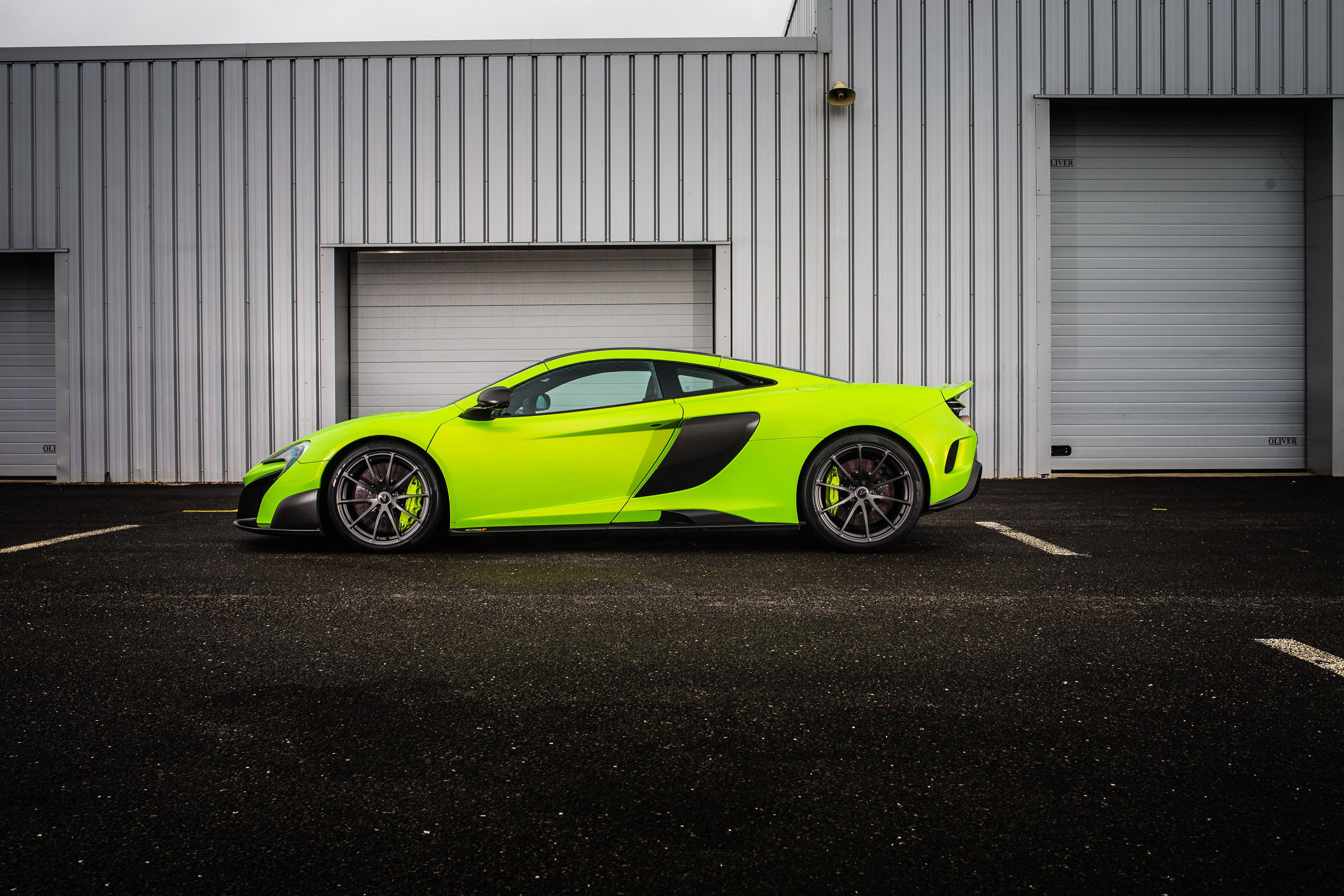 675lt, sports Car, street, motor Vehicle, side view, black color, car, sign, green, day, corrugated iron, new, supercar, modern, built structure, mode of Transport, HD Wallpaper