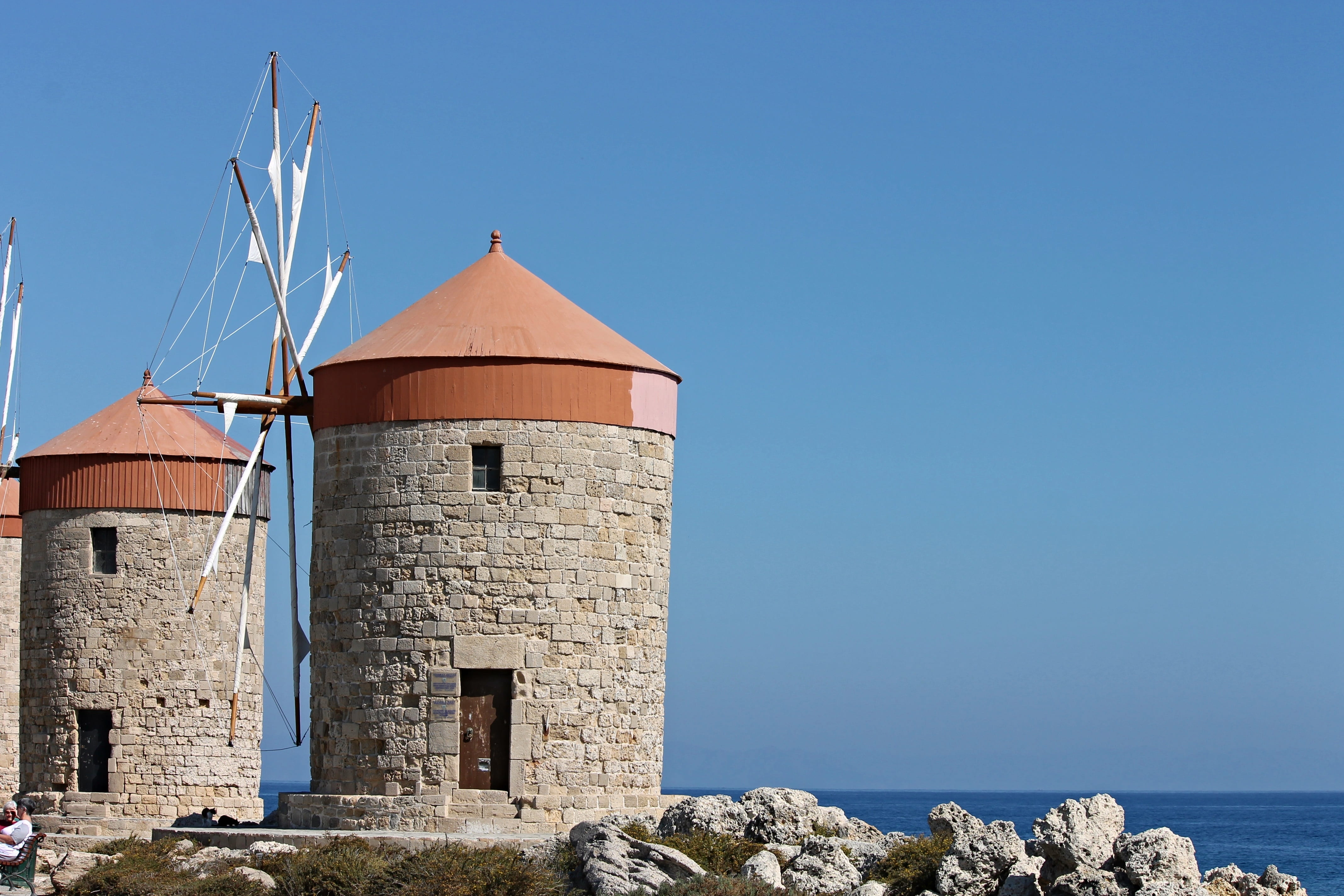 windmill, sky, daytime, wall, no people, land, old, wing, water, sea, sunlight, outdoors, 4K, tower, blue, brown, architecture, concrete, stone, building exterior, HD Wallpaper