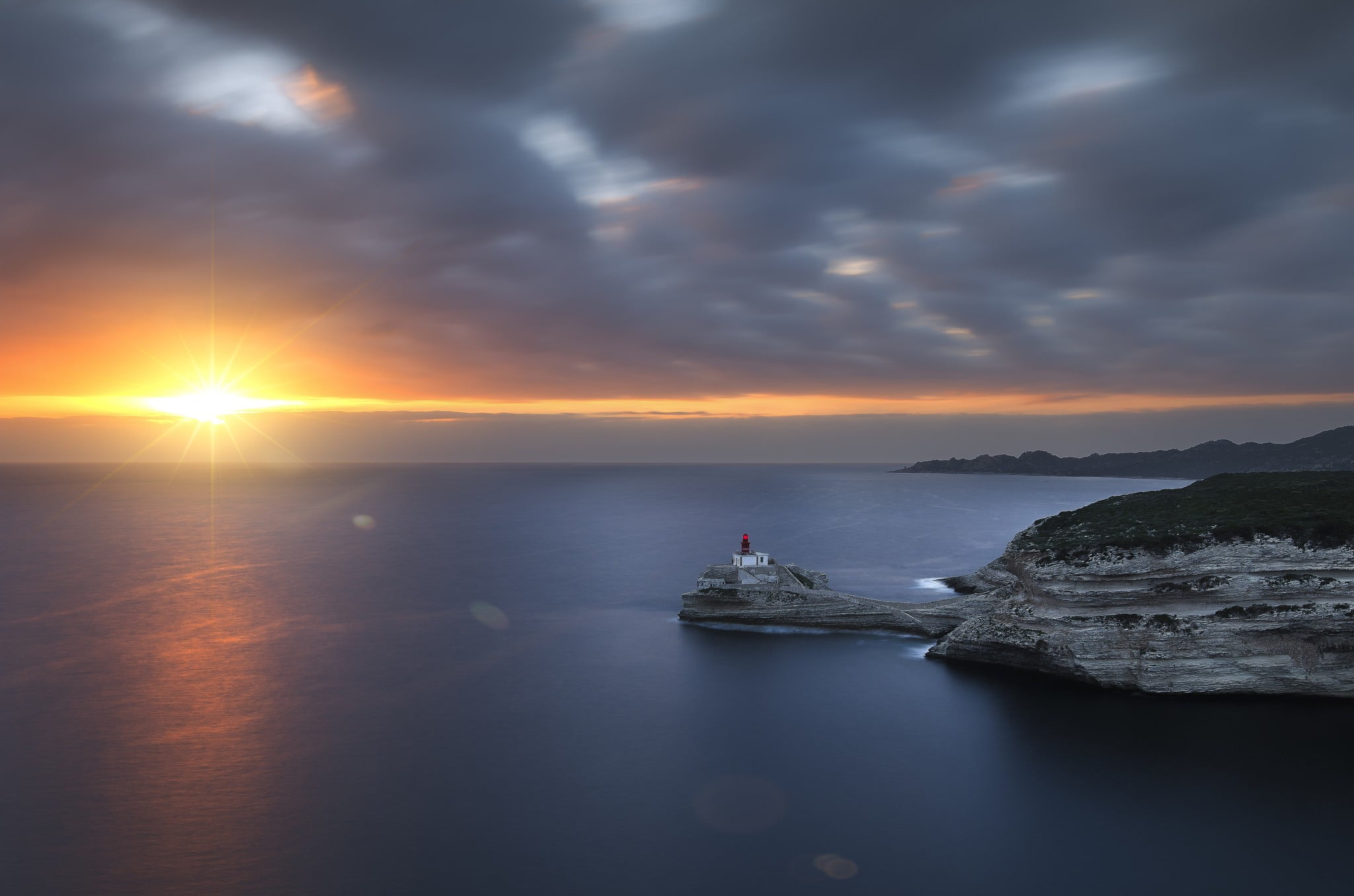 sky, lighthouse, outdoors, mountains, water, rocks, 1080P, tv, horizon over water, clouds, cloud - sky, tranquil scene, horizon, screen, Sun, tranquility, HD Wallpaper